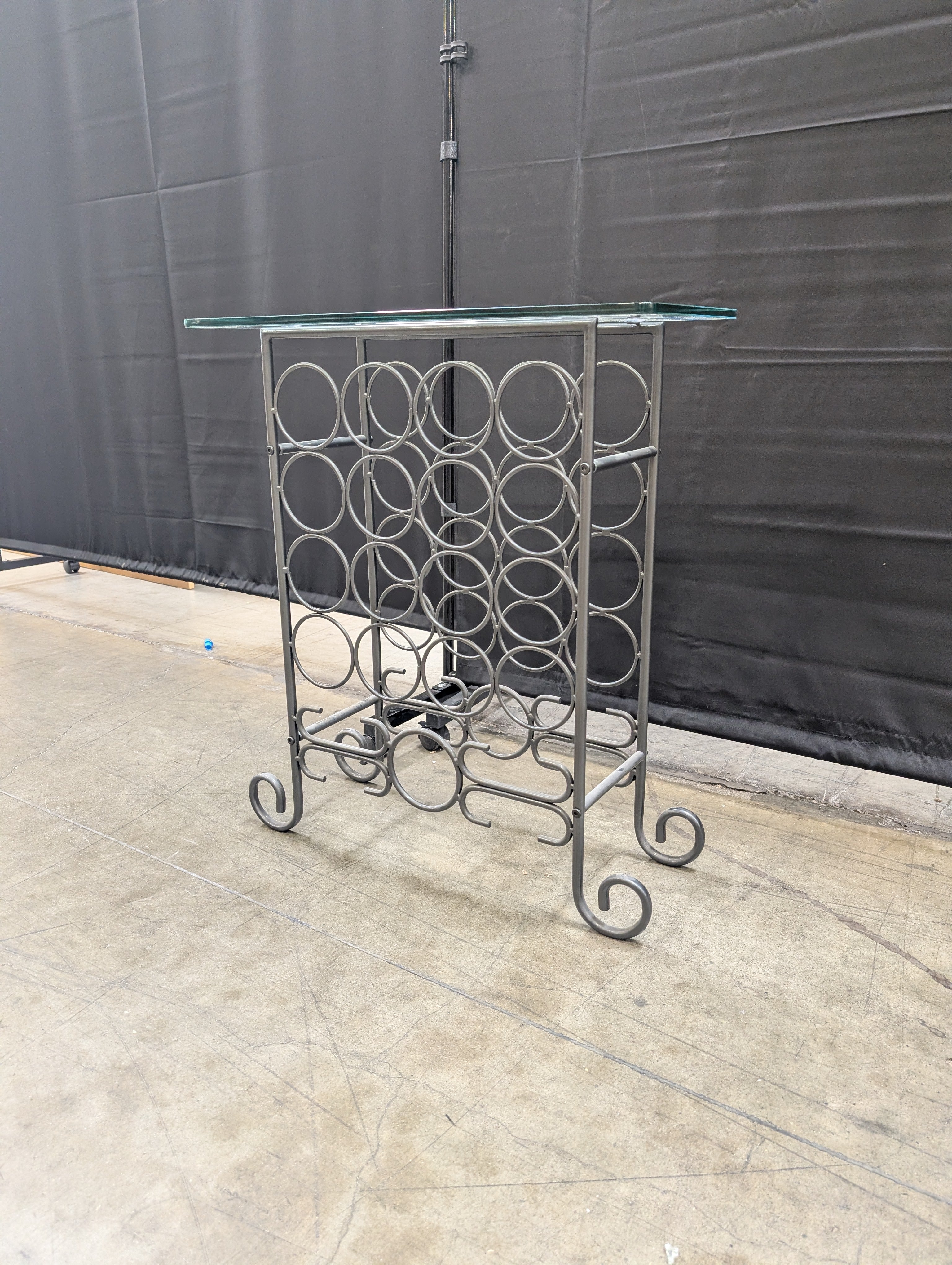 Industrial Style Metal Wine Rack with Glass Top and Wheels