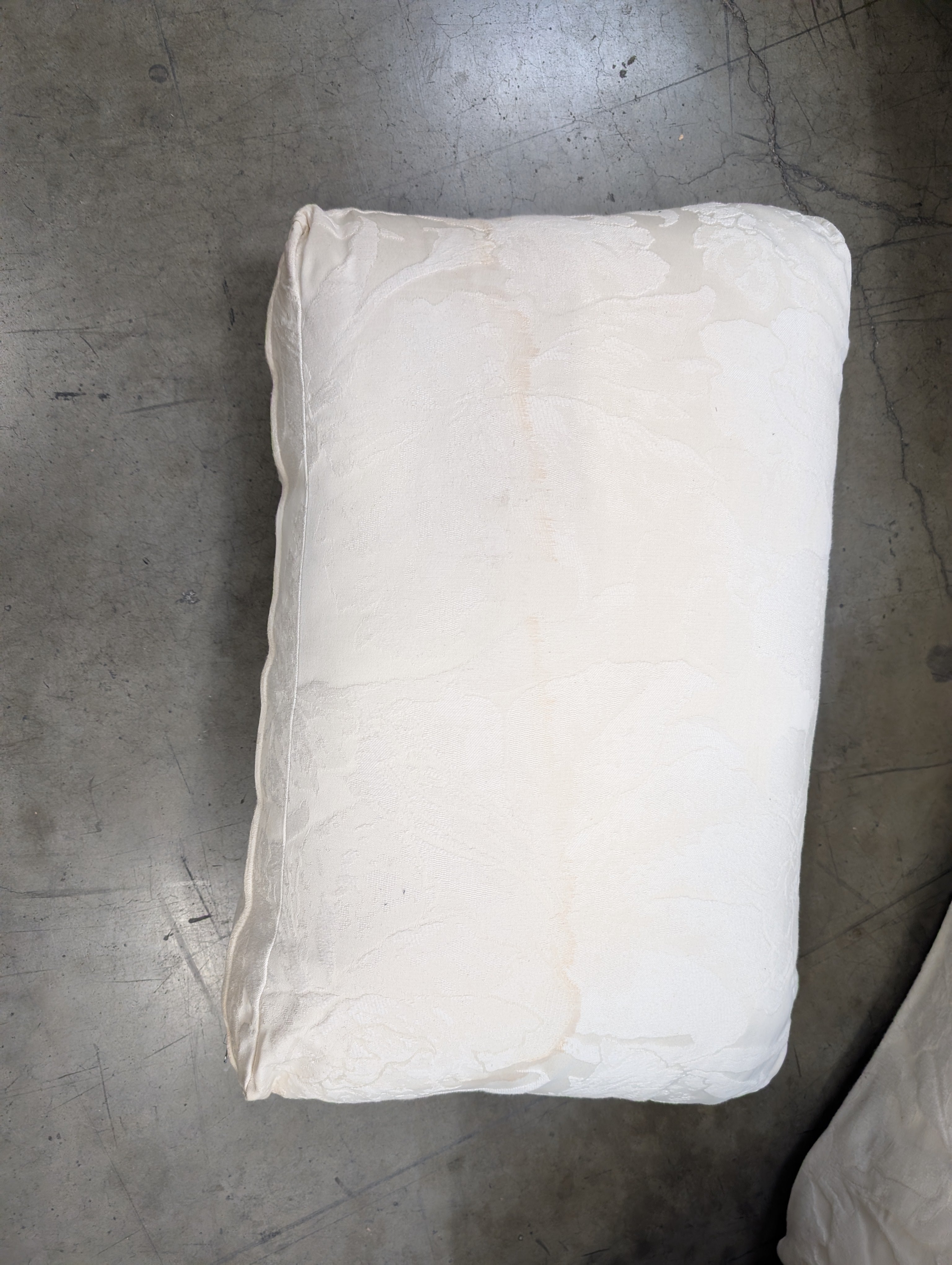 Has a stain Curved Cream Fabric Sectional Sofa with Rolled Arms