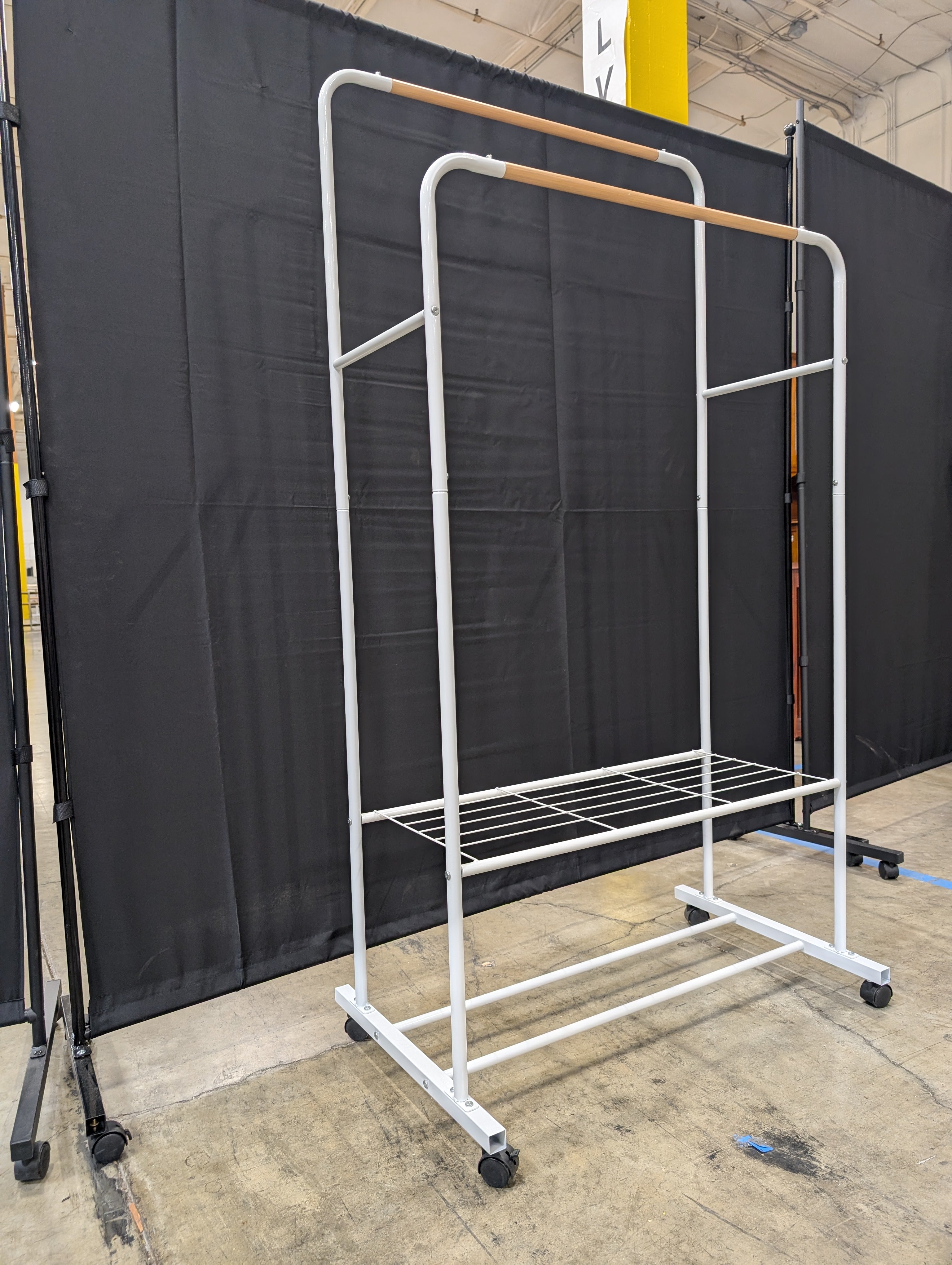 White Metal Rolling Garment Rack with Dual Hanging Rails and Storage Shelf