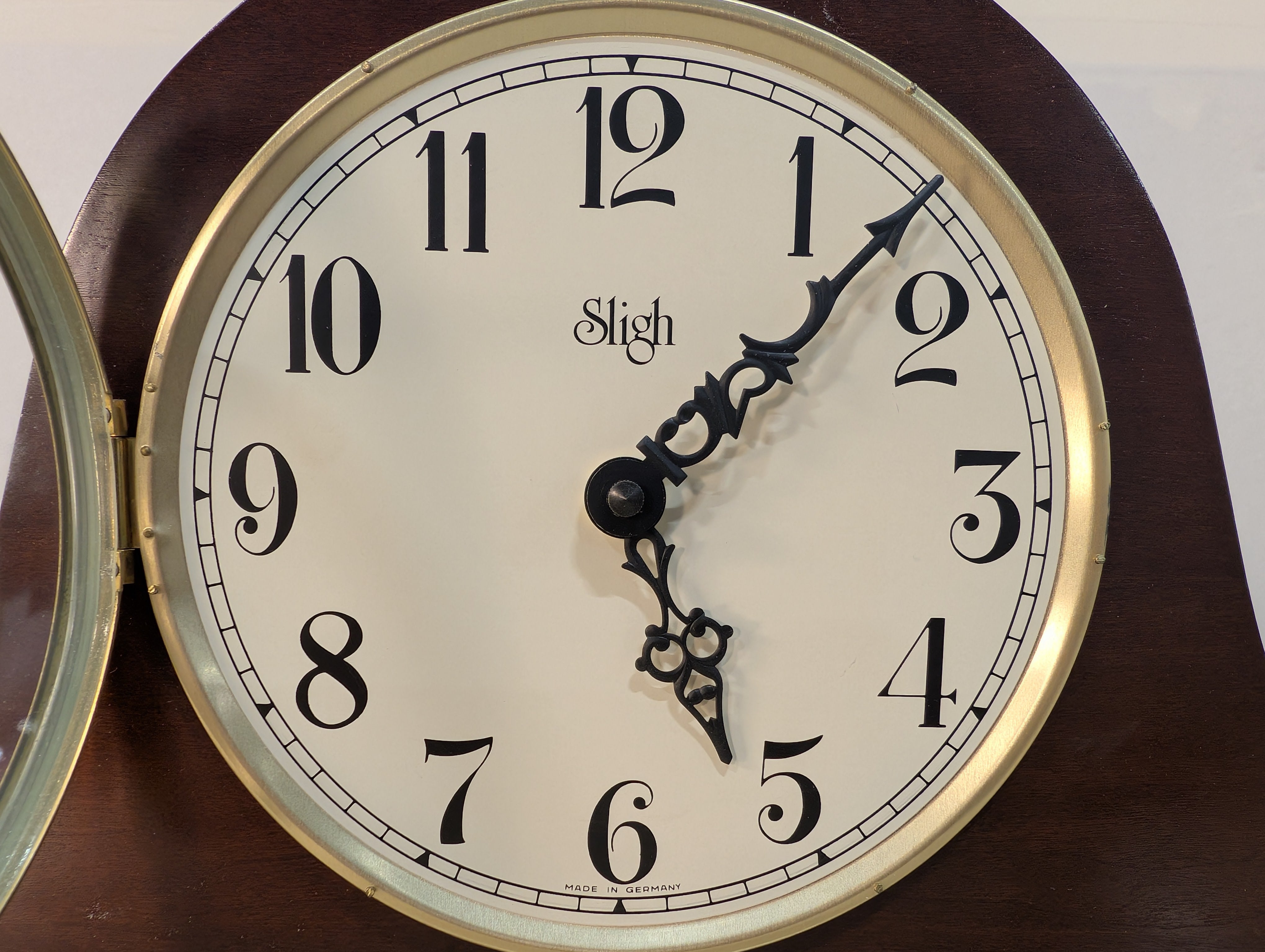 Curved Dark Wood Table Clock with Brass Tone Bezel