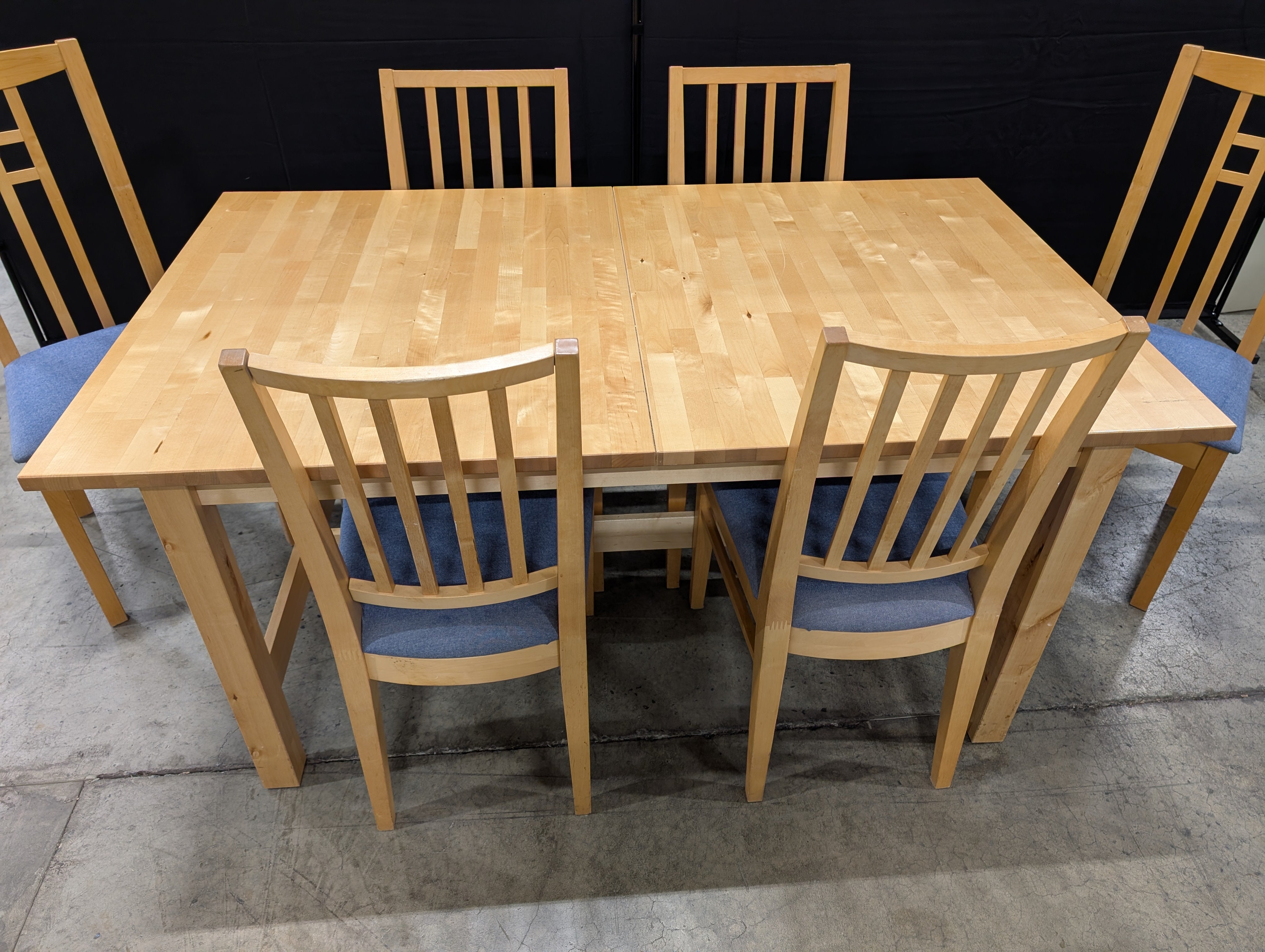 Versatile Extendable Light Wood Dining Table with Six Blue Upholstered Chairs