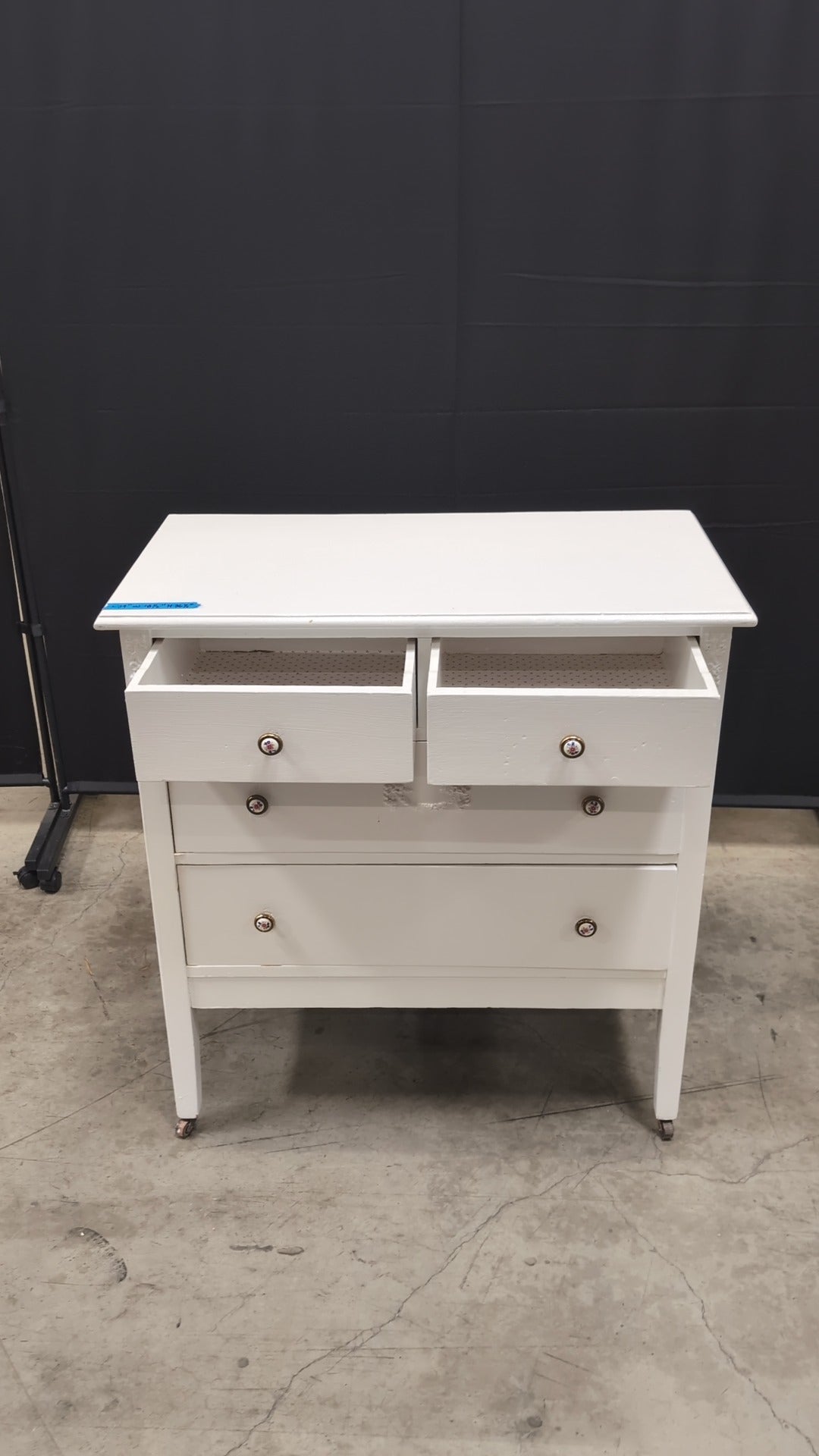 Charming White Four-Drawer Chest with Decorative Knobs
