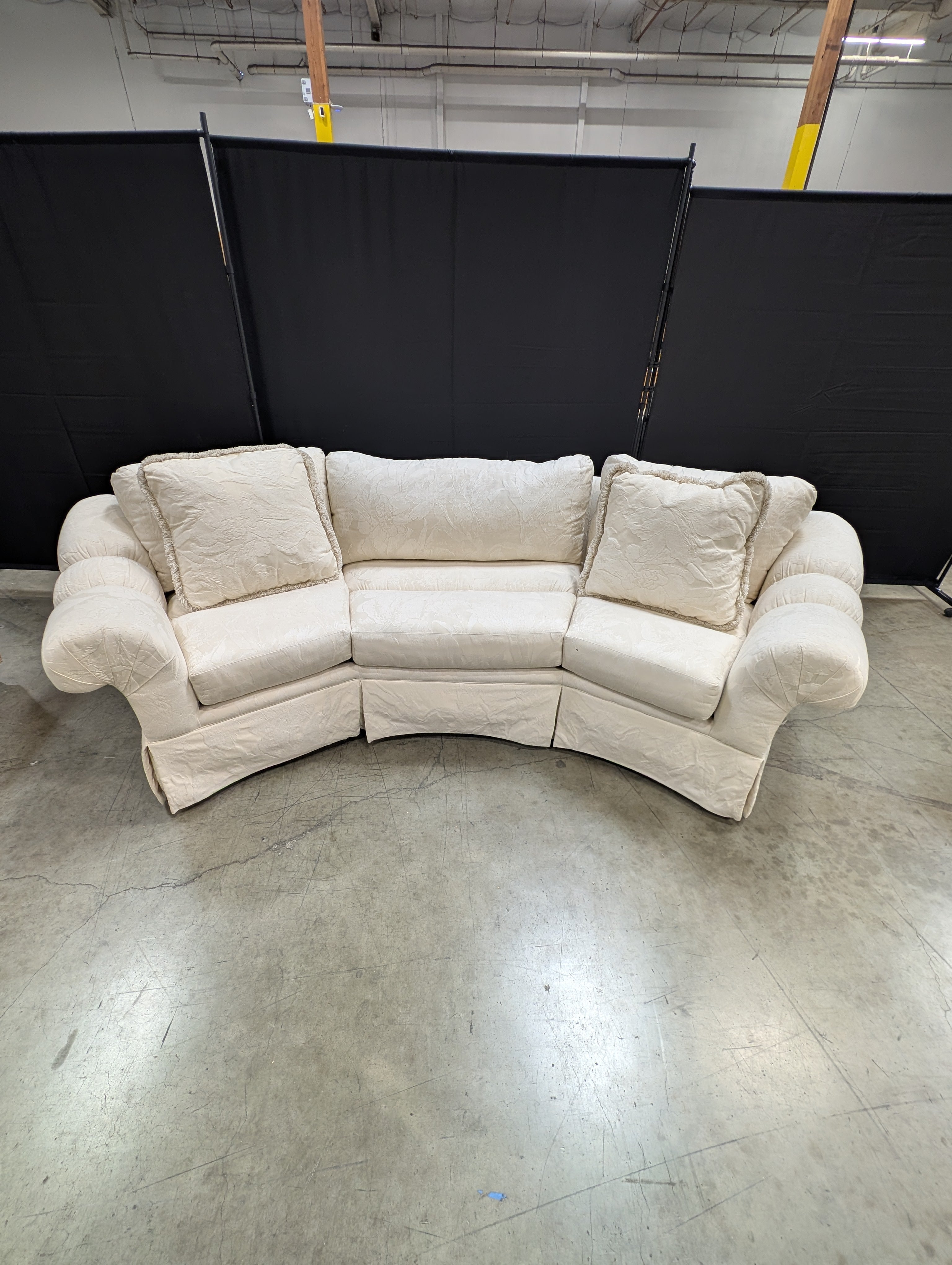 Has a stain Curved Cream Fabric Sectional Sofa with Rolled Arms