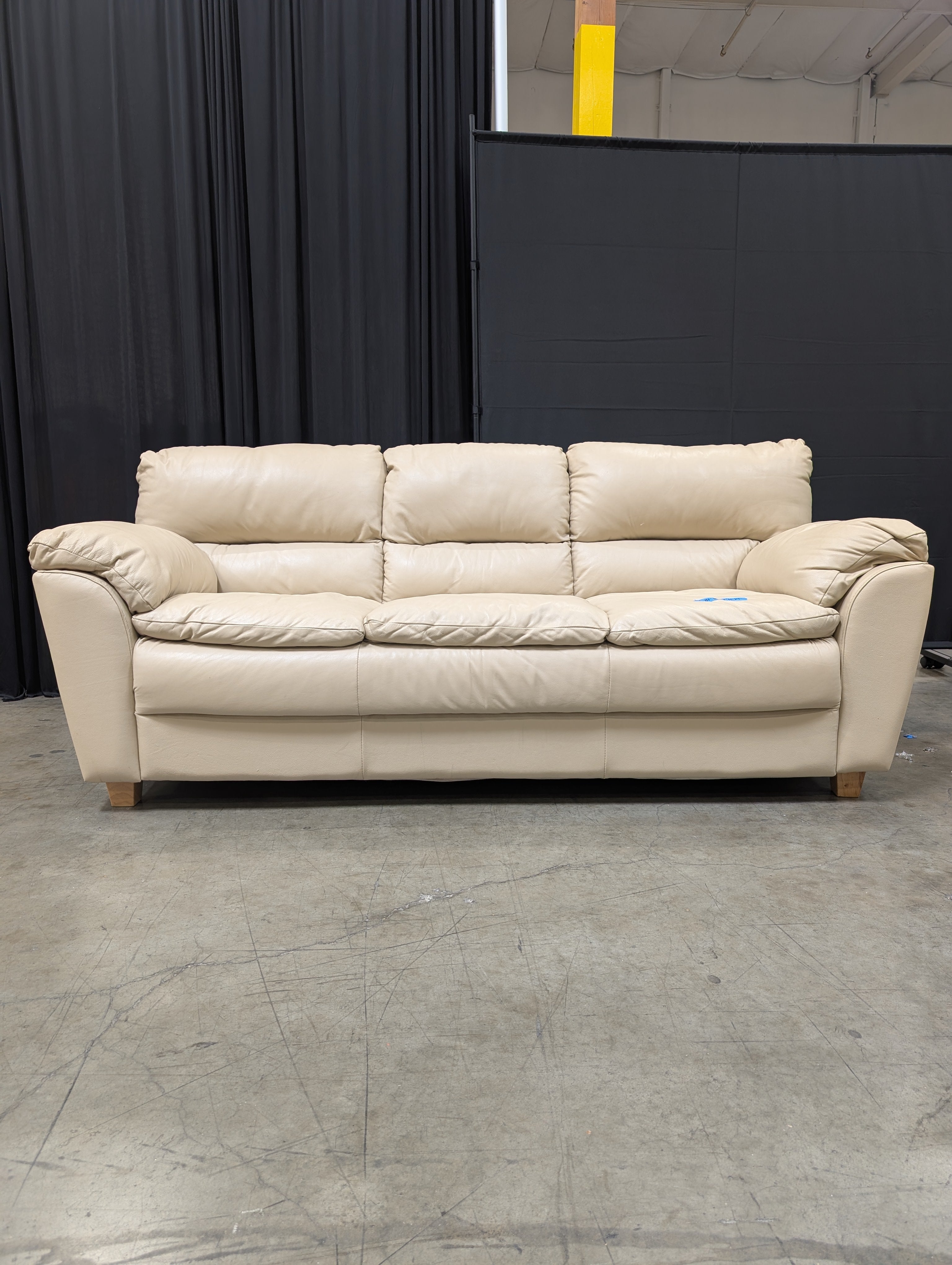 Cream Three-Seat Leather Couch with Pillow Arms
