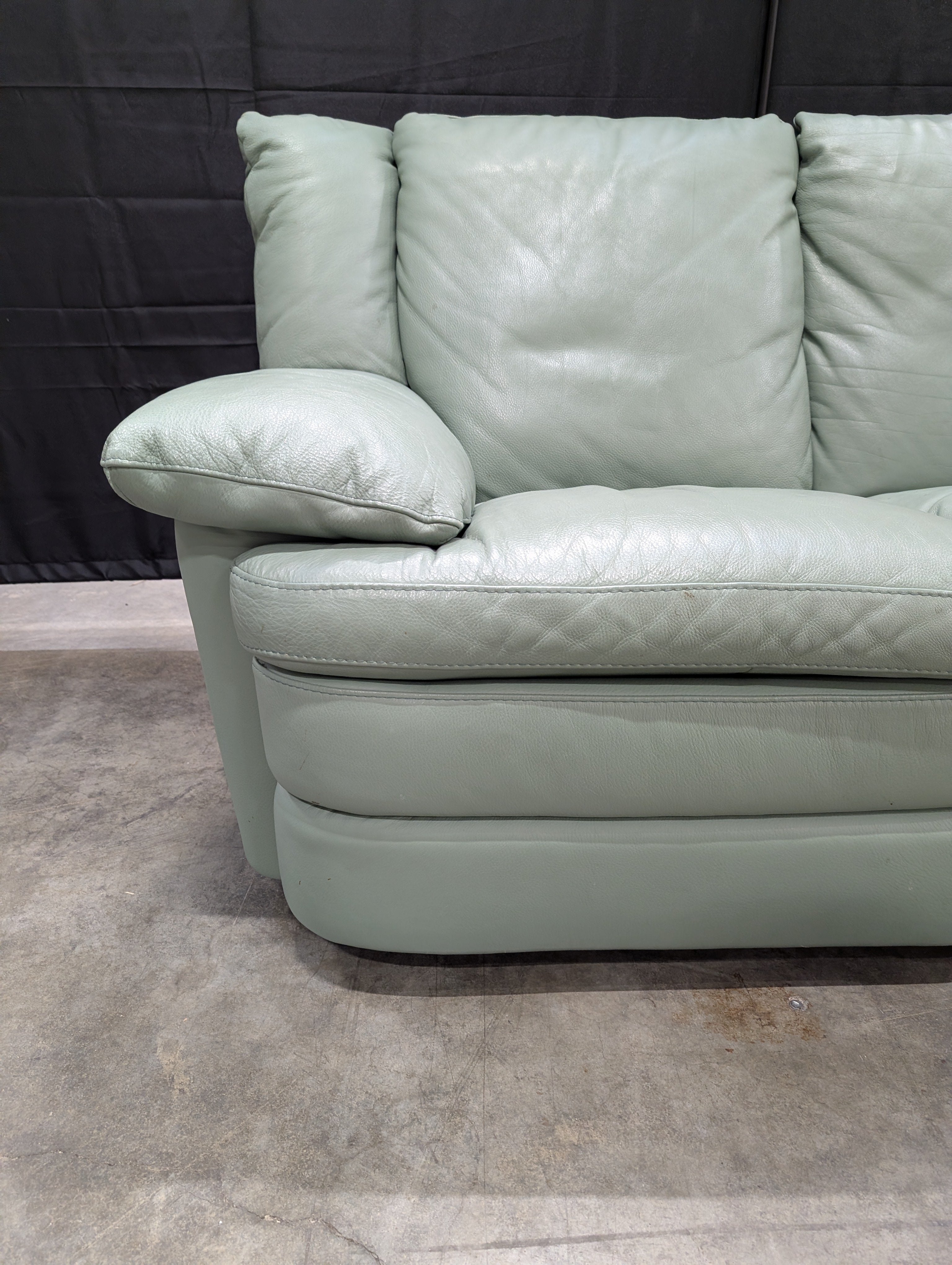Charming Mint Green Leather Two-Seater Sofa with Plush Padded Arms