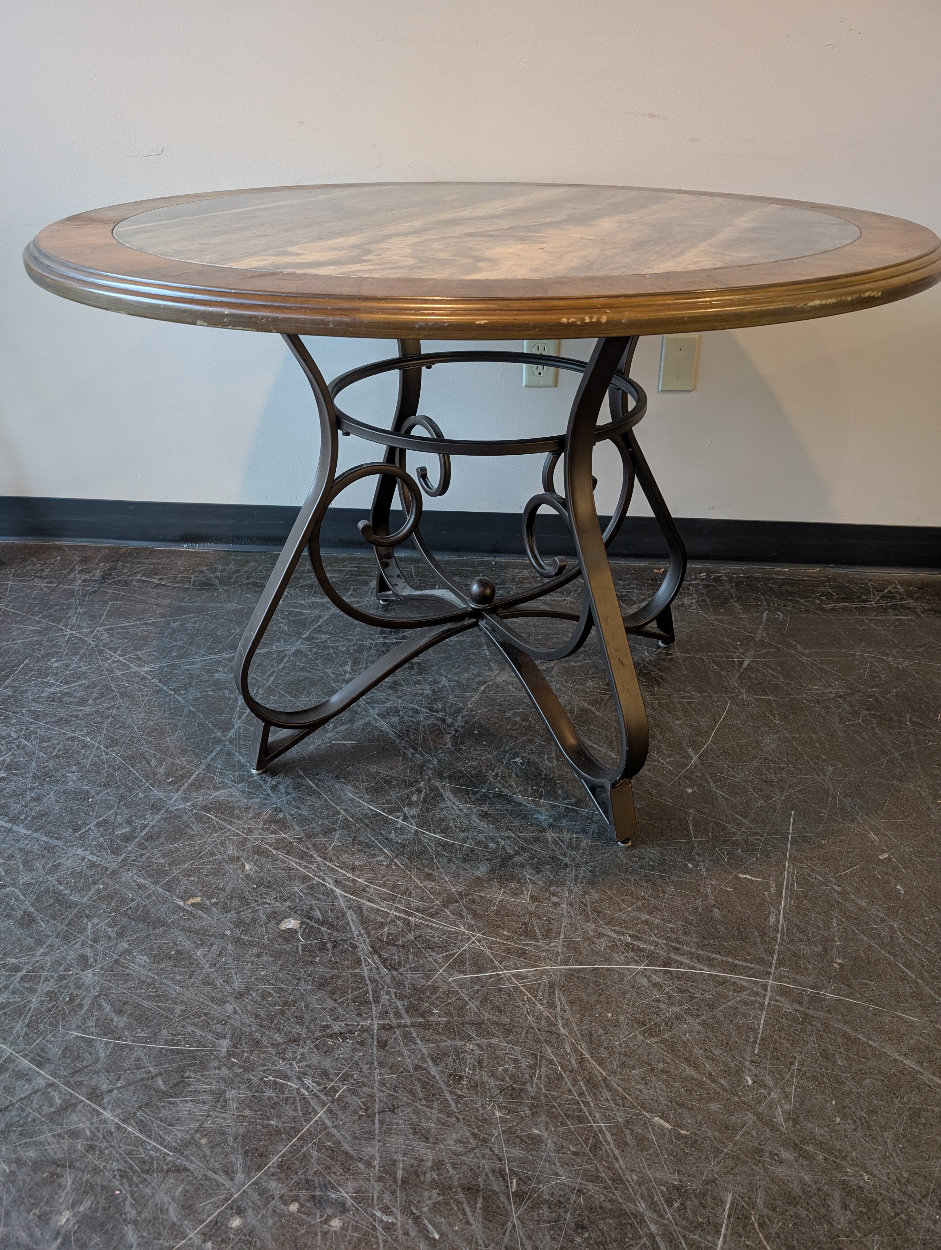 Round Stone Top Dining Table with Wood Trim and Metal Pedestal Base