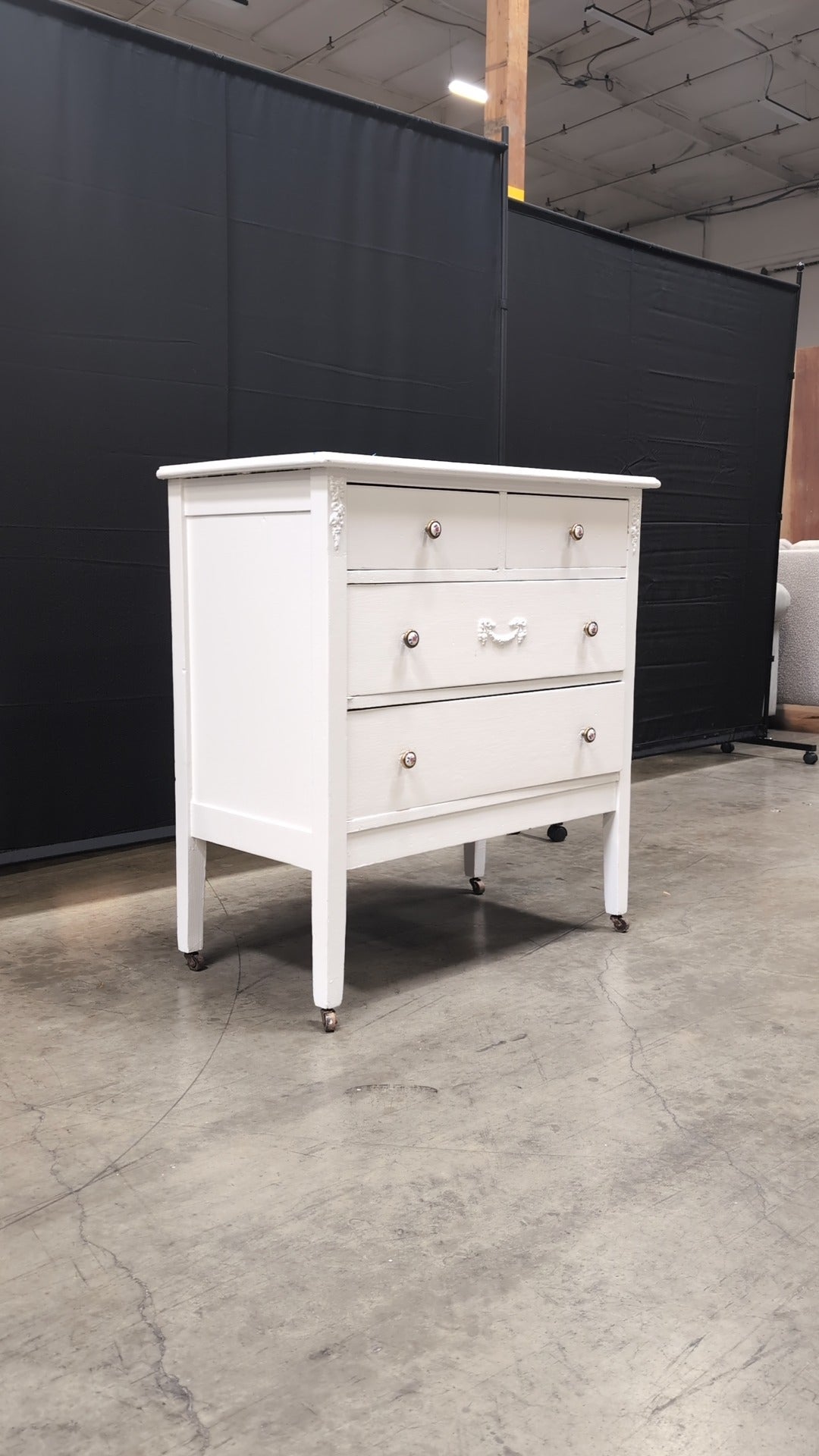 Charming White Four-Drawer Chest with Decorative Knobs