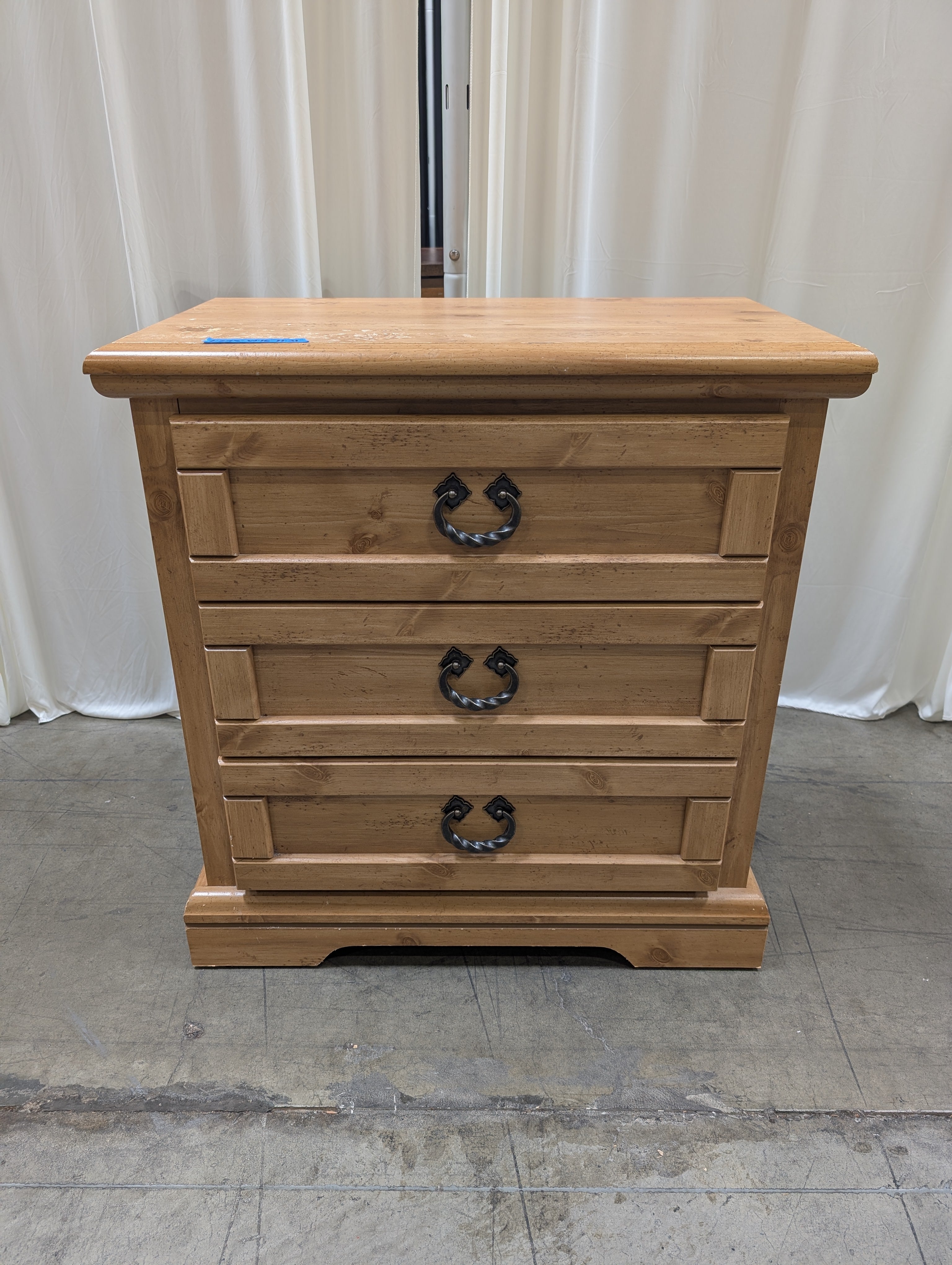 Light Wood Three-Drawer Nightstand with Metal Pulls