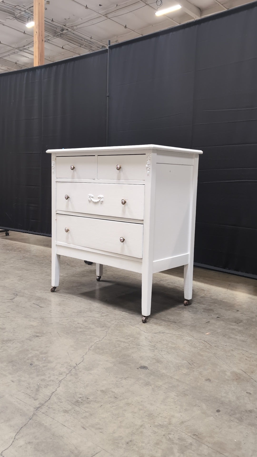 Charming White Four-Drawer Chest with Decorative Knobs