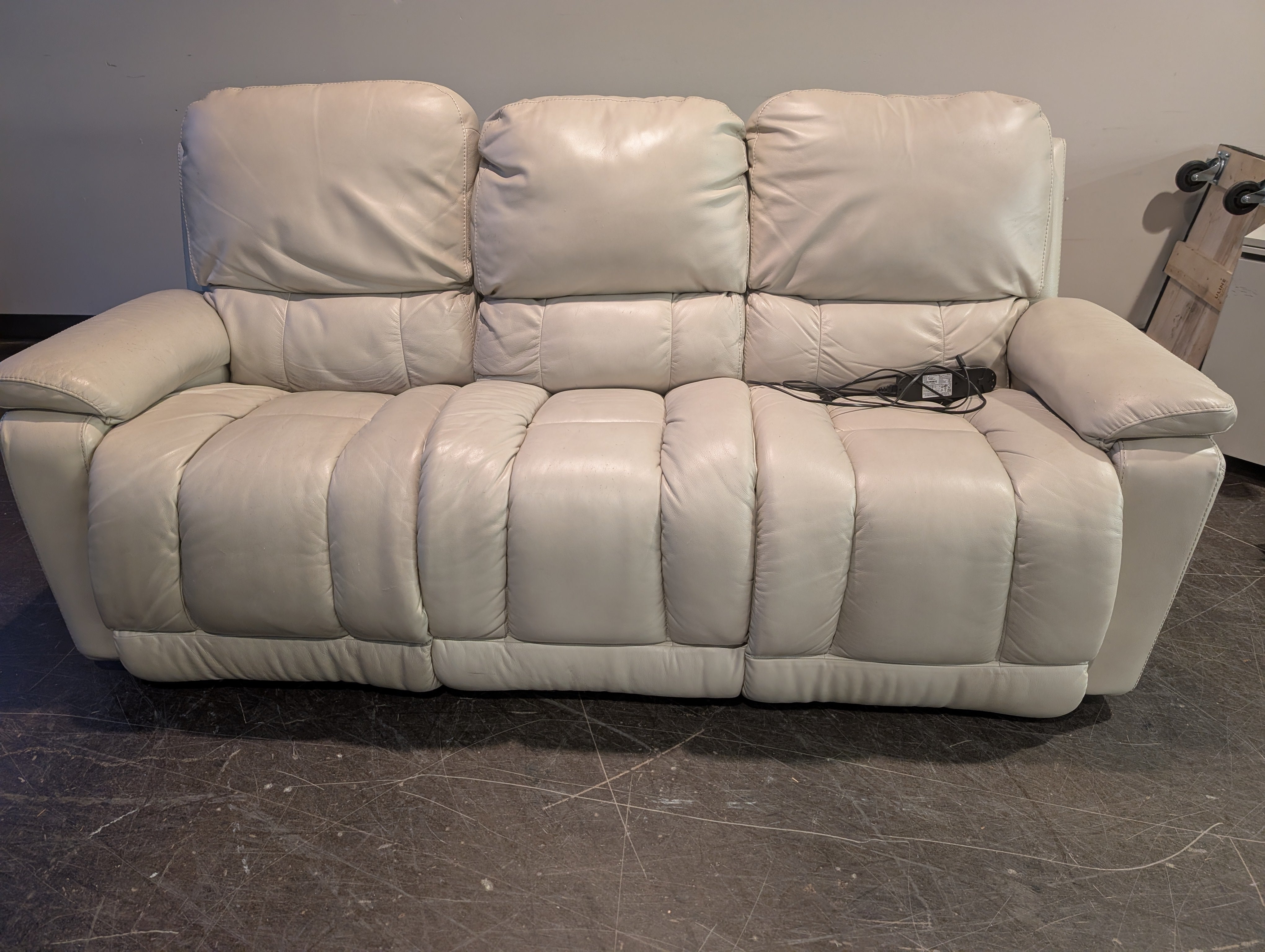 Cream Upholstered Two-Seater Reclining Sofa