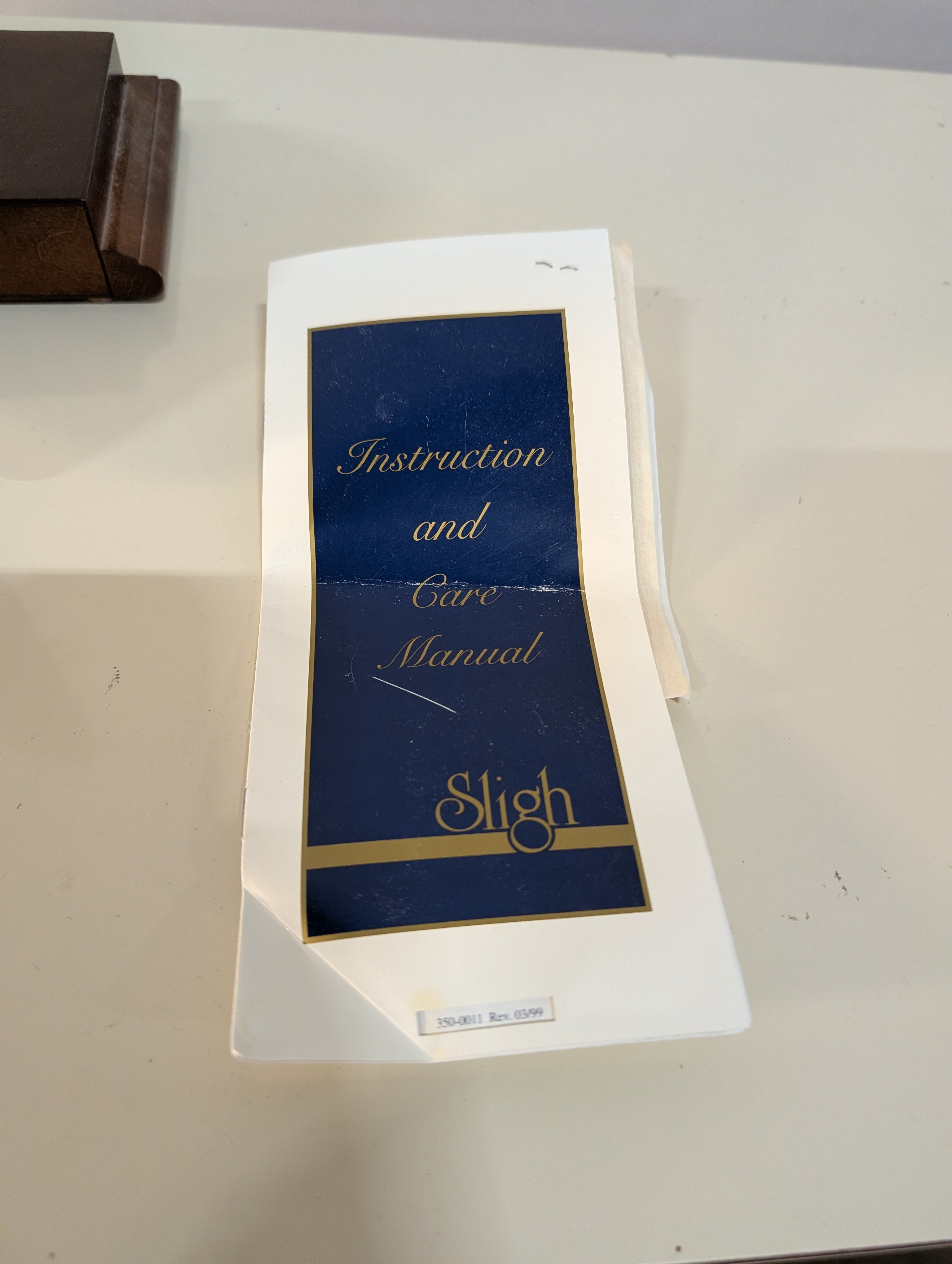 Curved Dark Wood Table Clock with Brass Tone Bezel