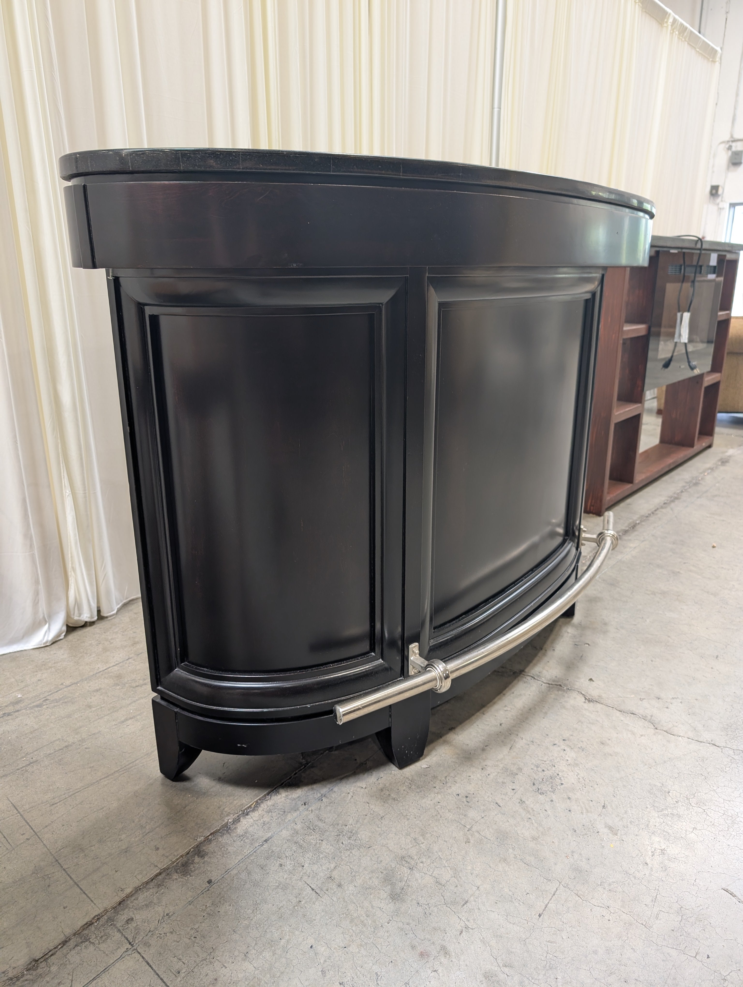 Dark Curved Wood Home Bar with Metal Foot Rail