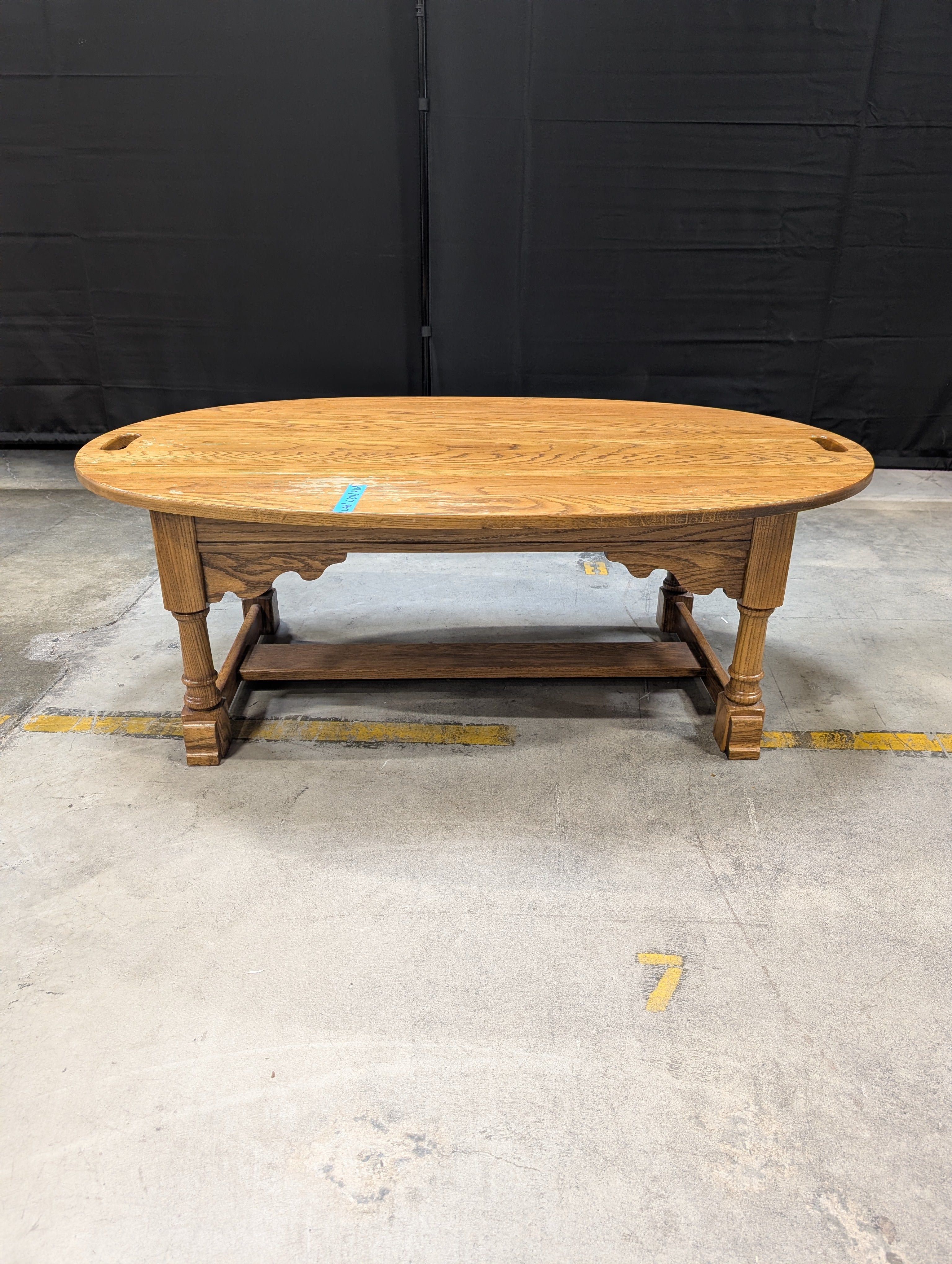 Oval Light Brown Wood Coffee Table with Cut-Out Handles