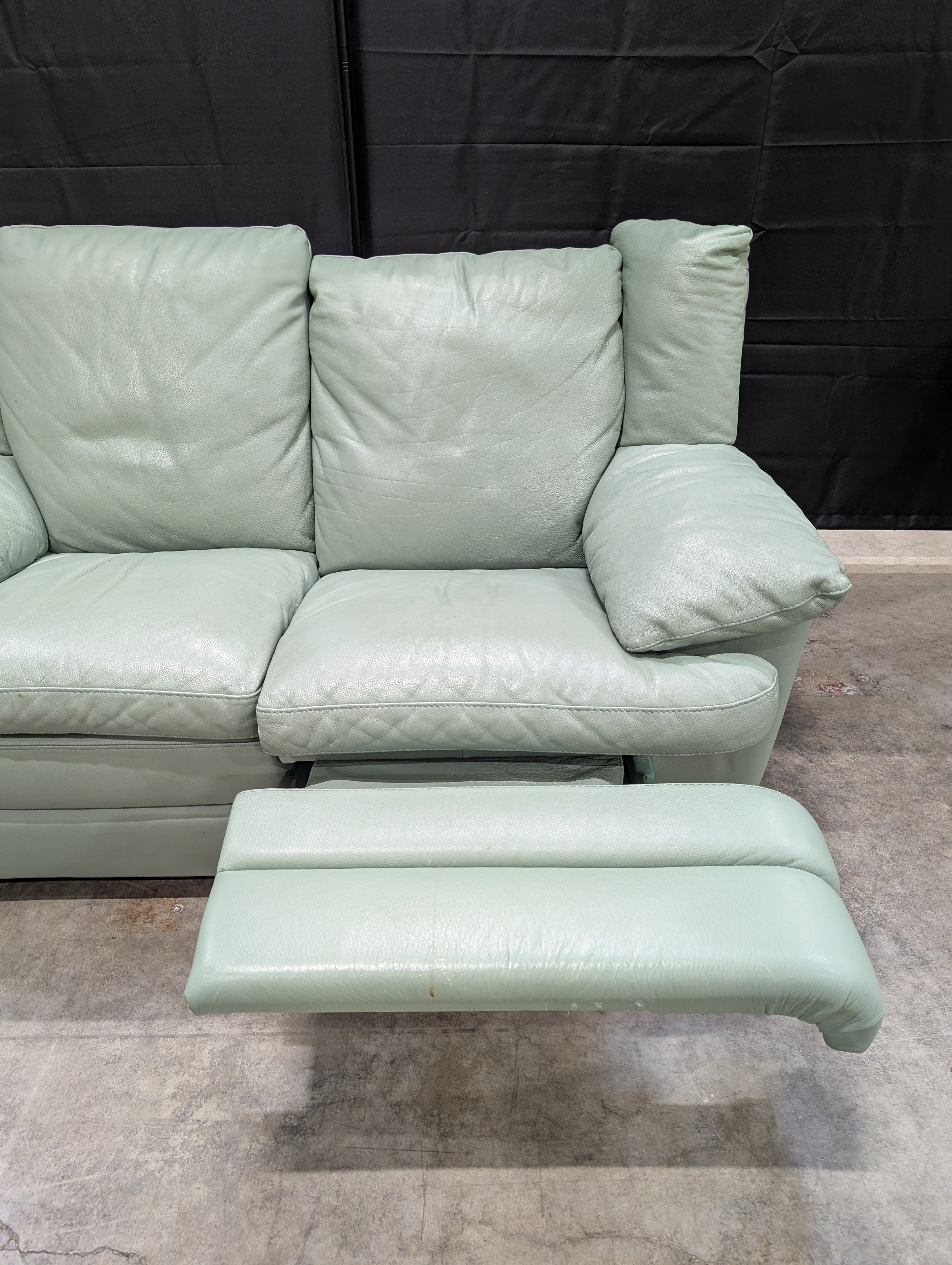 Charming Mint Green Leather Two-Seater Sofa with Plush Padded Arms