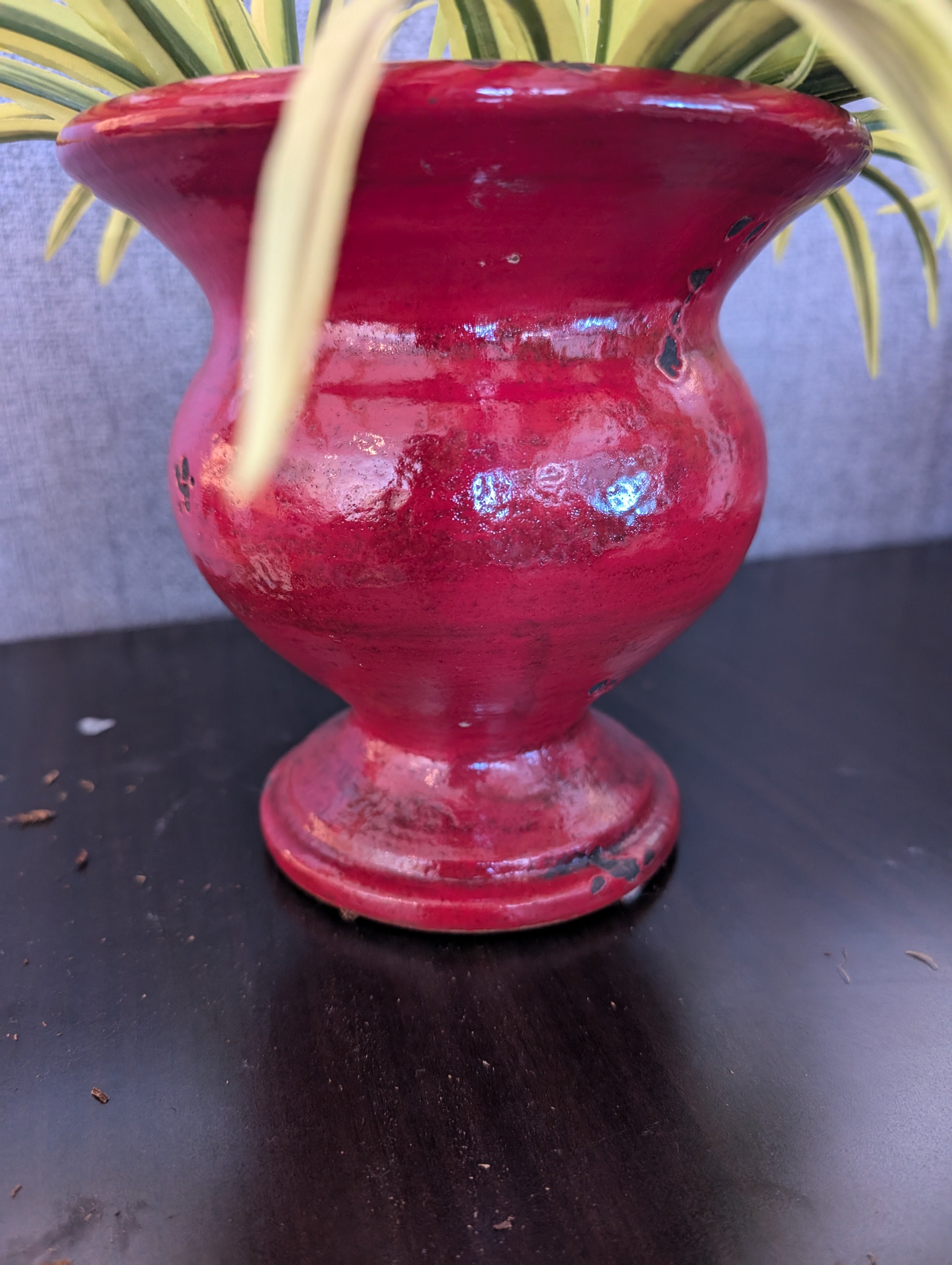 Vibrant Faux Variegated Plant in Red Decorative Pot