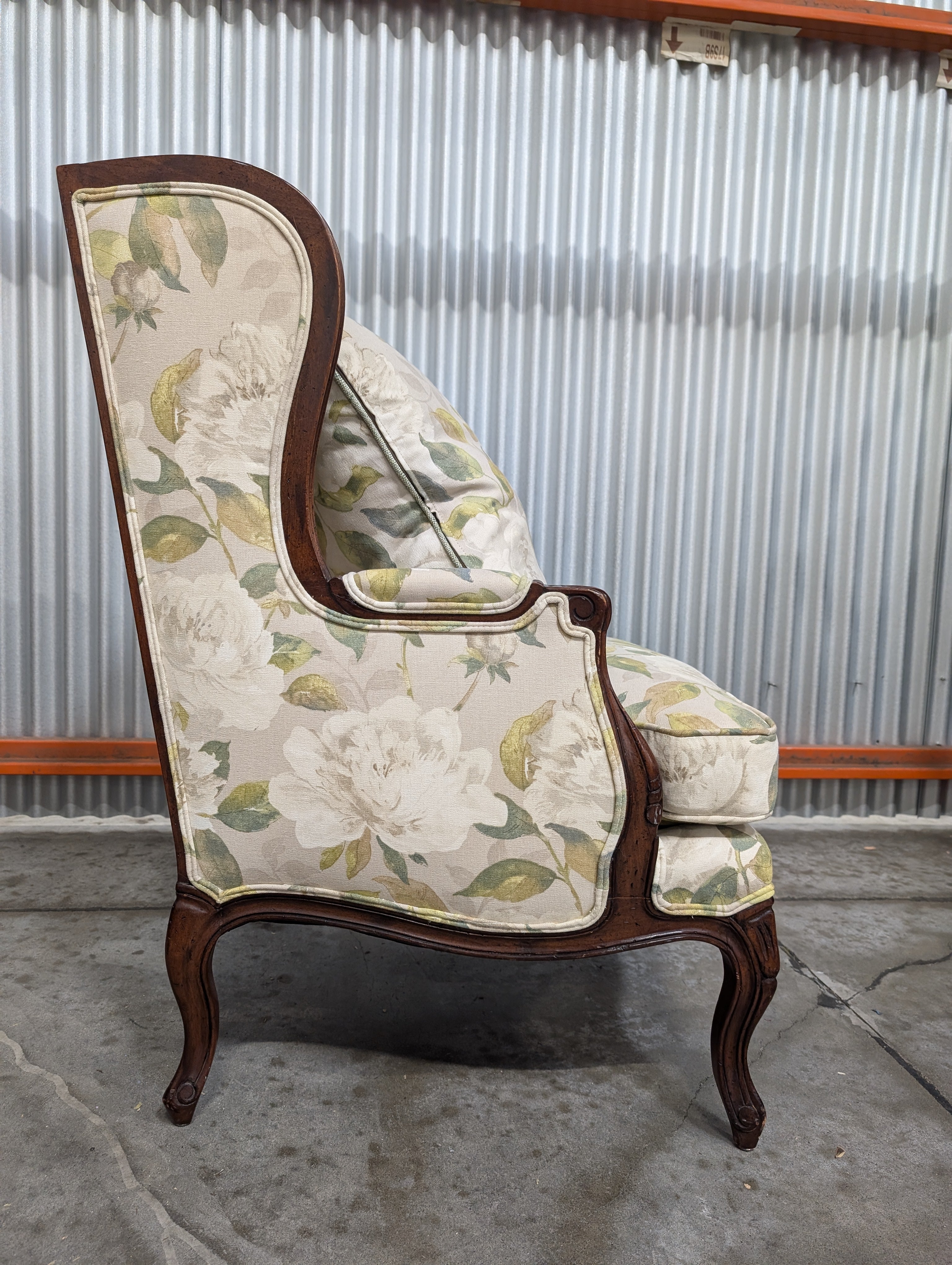 Vintage Wingback Armchair with Floral Upholstery and Carved Wood Frame