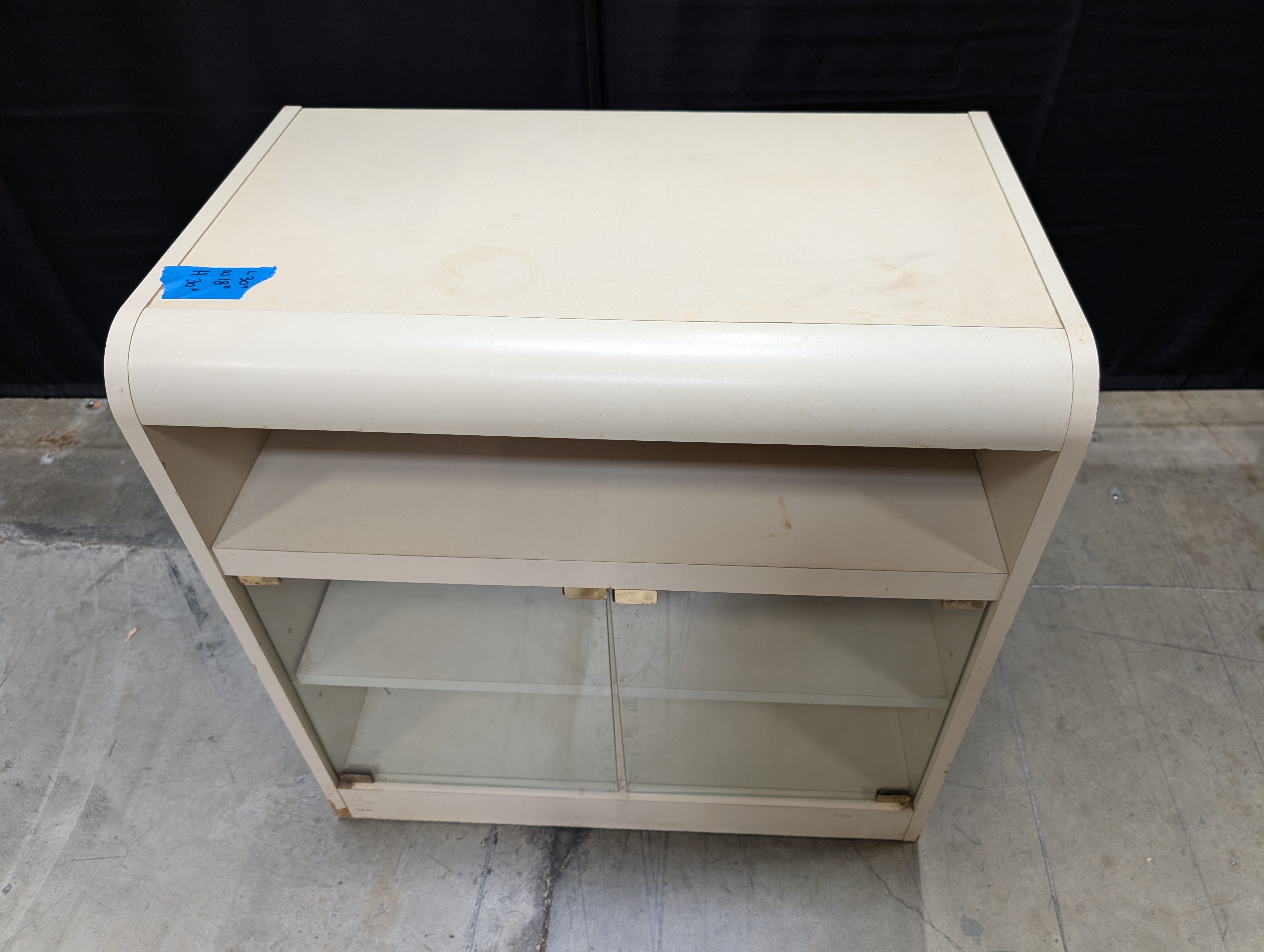 Compact Cream Storage Cabinet with Glass Doors and Curved Design
