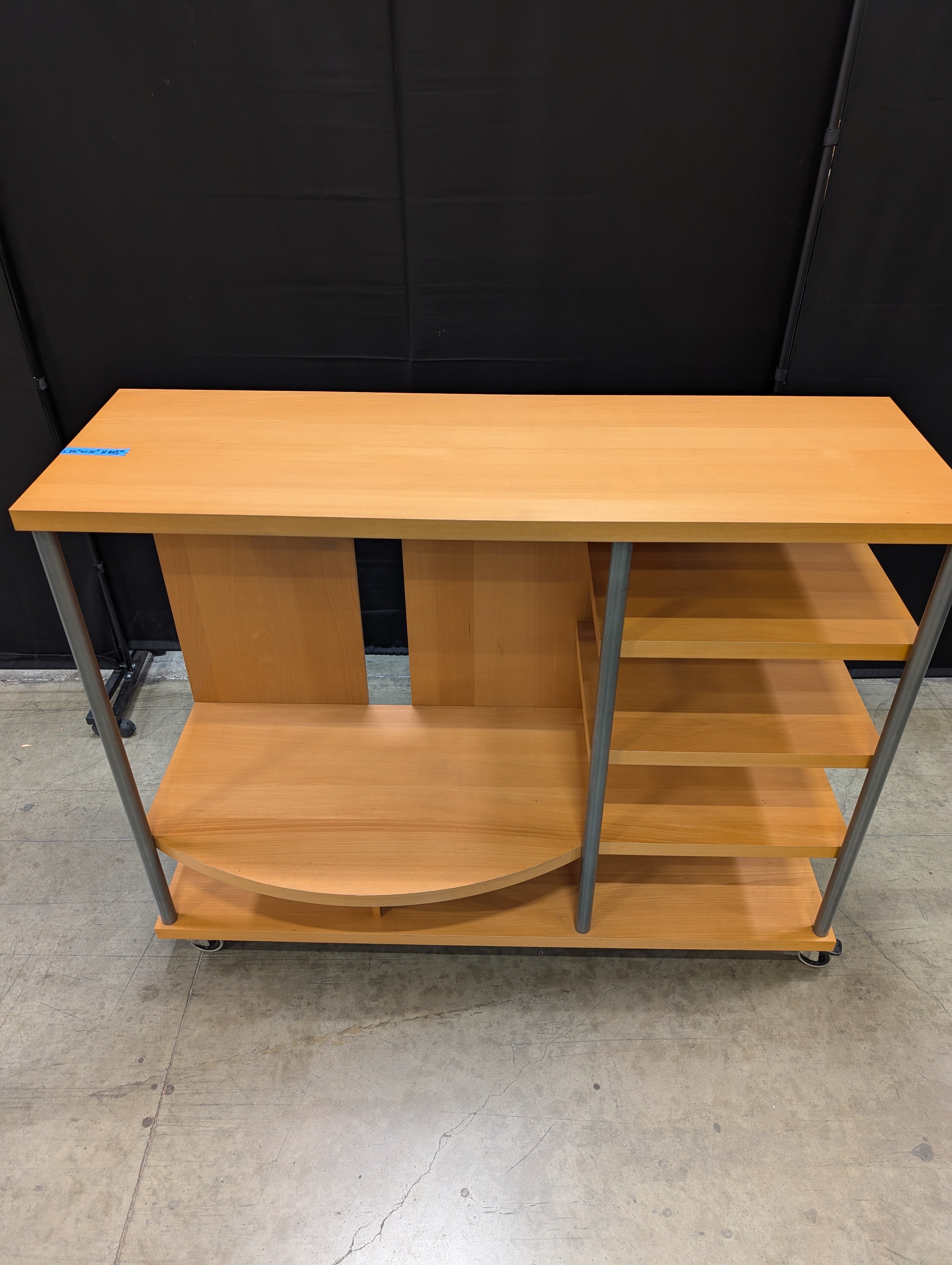 Contemporary Wood Tone Shelving Unit with Metal Supports and Casters