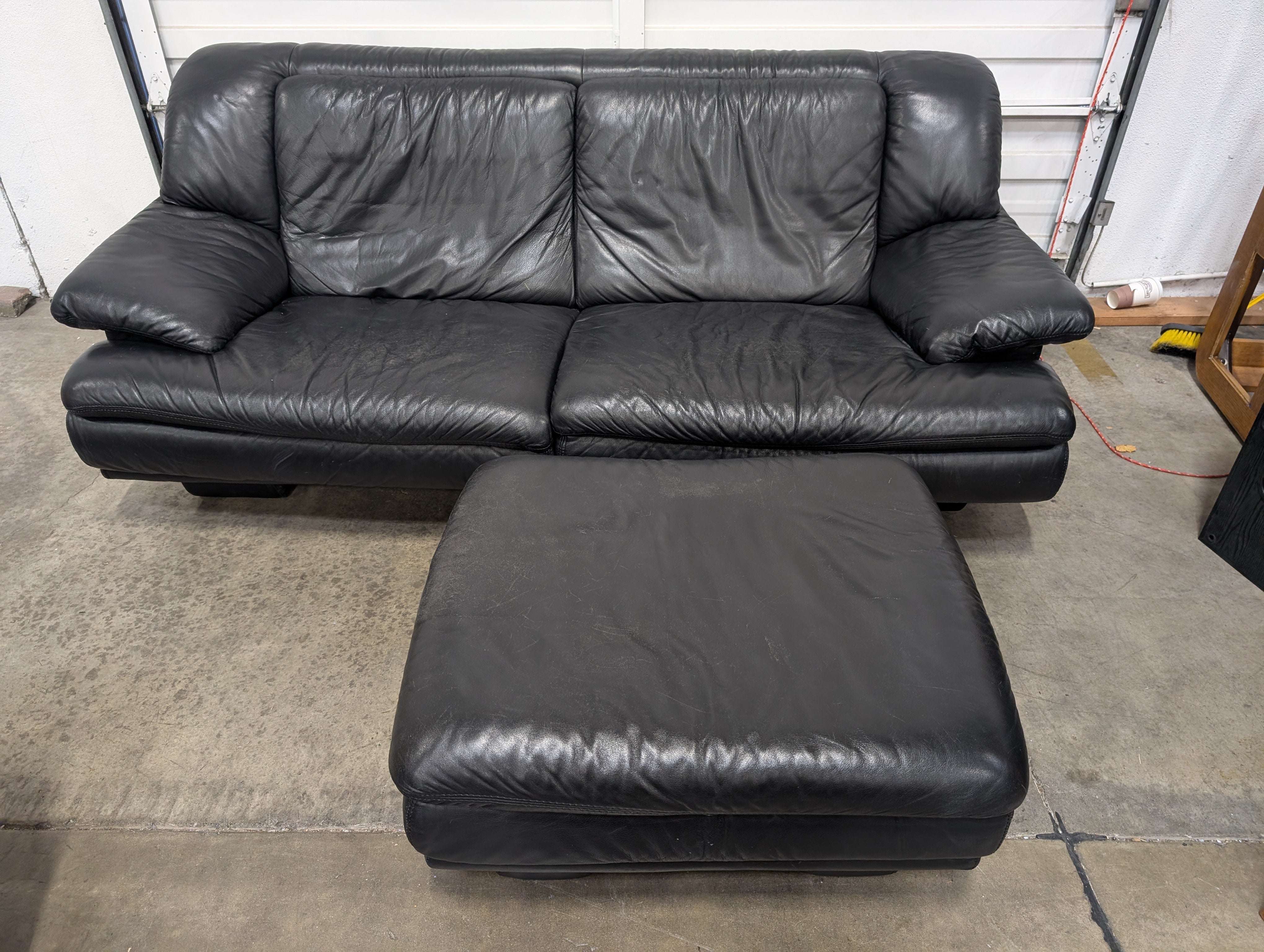 Natuzzi Spacious Black Leather Three-Seater Sofa with Ottoman