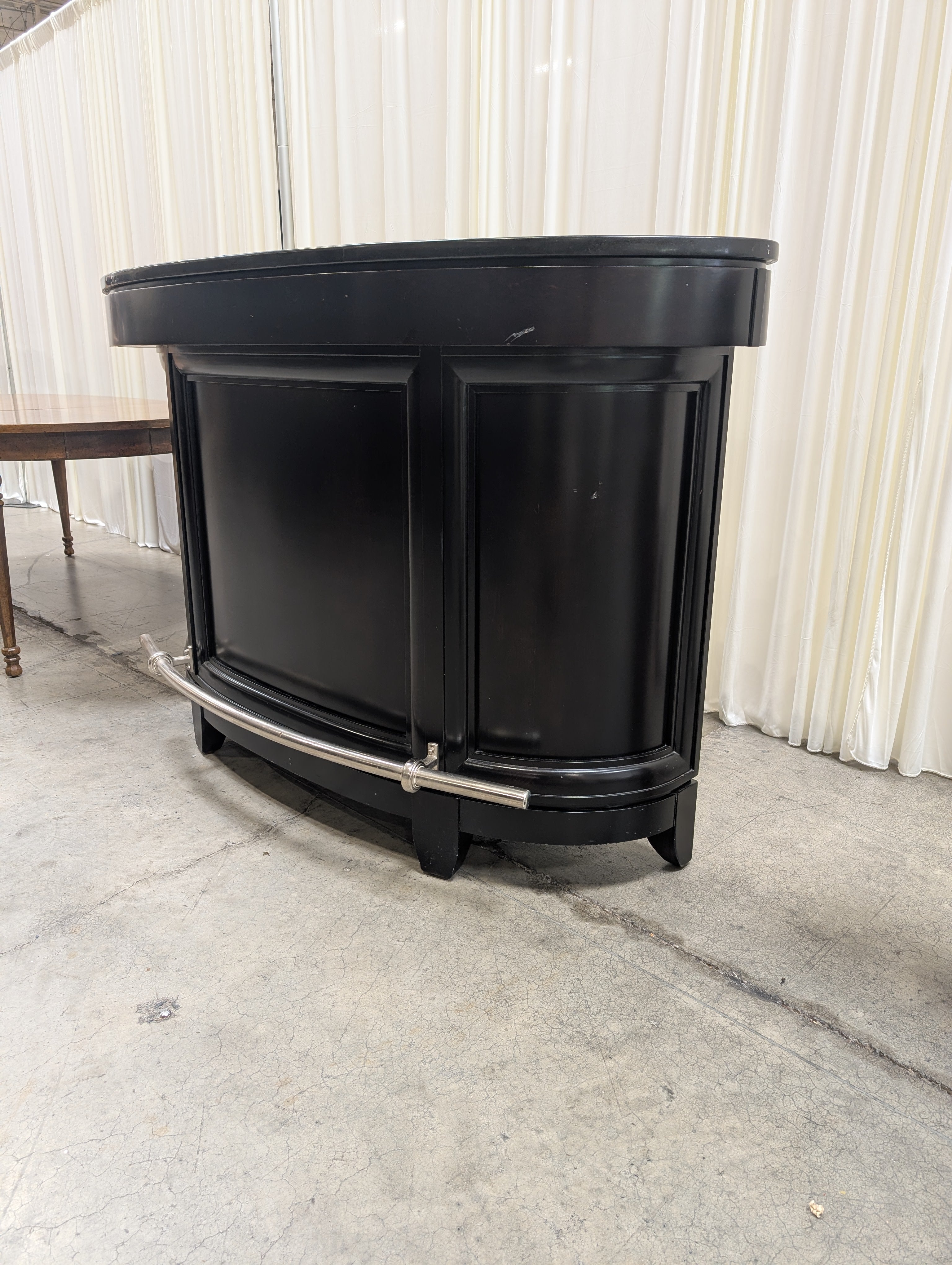 Dark Curved Wood Home Bar with Metal Foot Rail