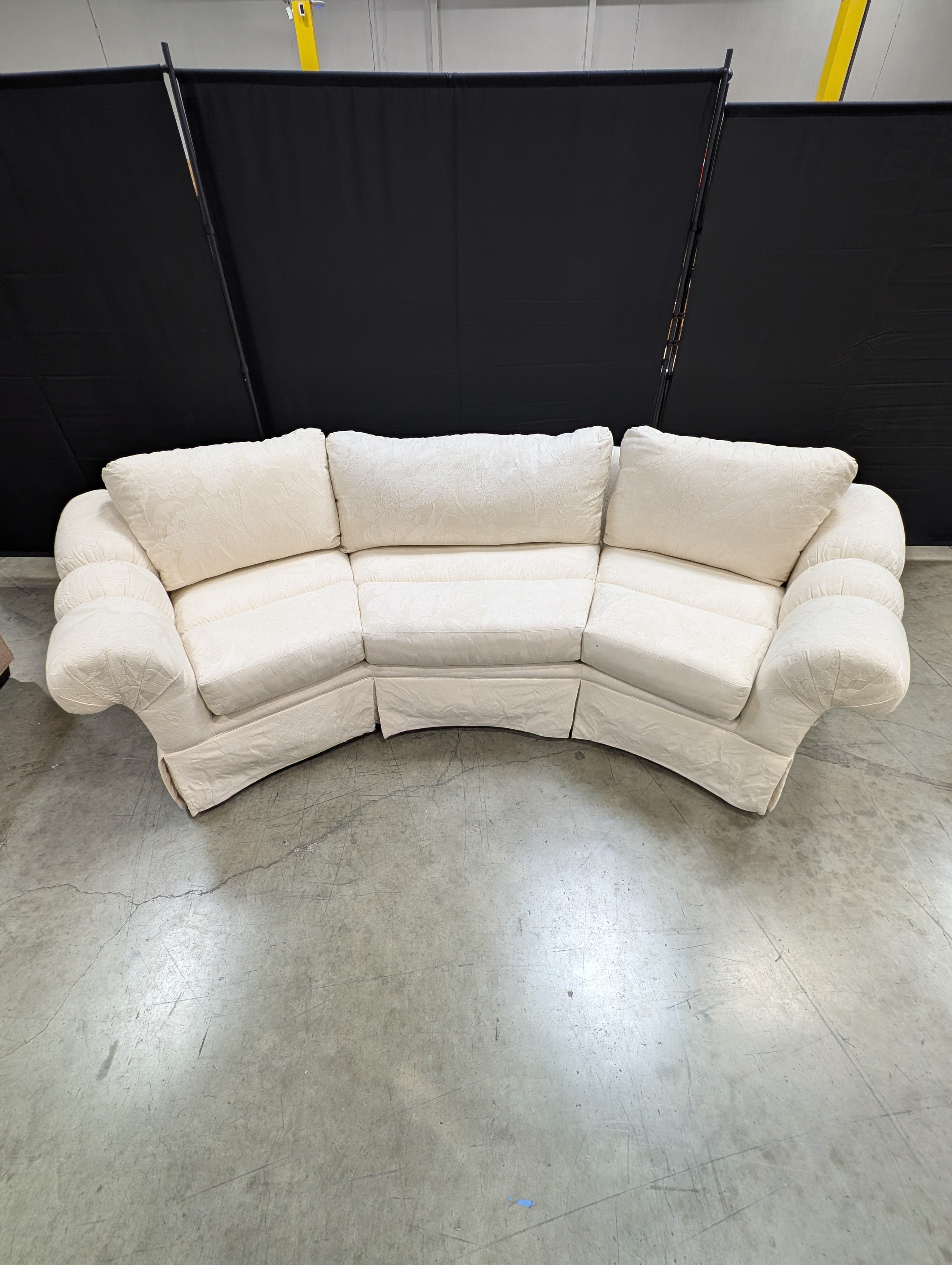 Has a stain Curved Cream Fabric Sectional Sofa with Rolled Arms