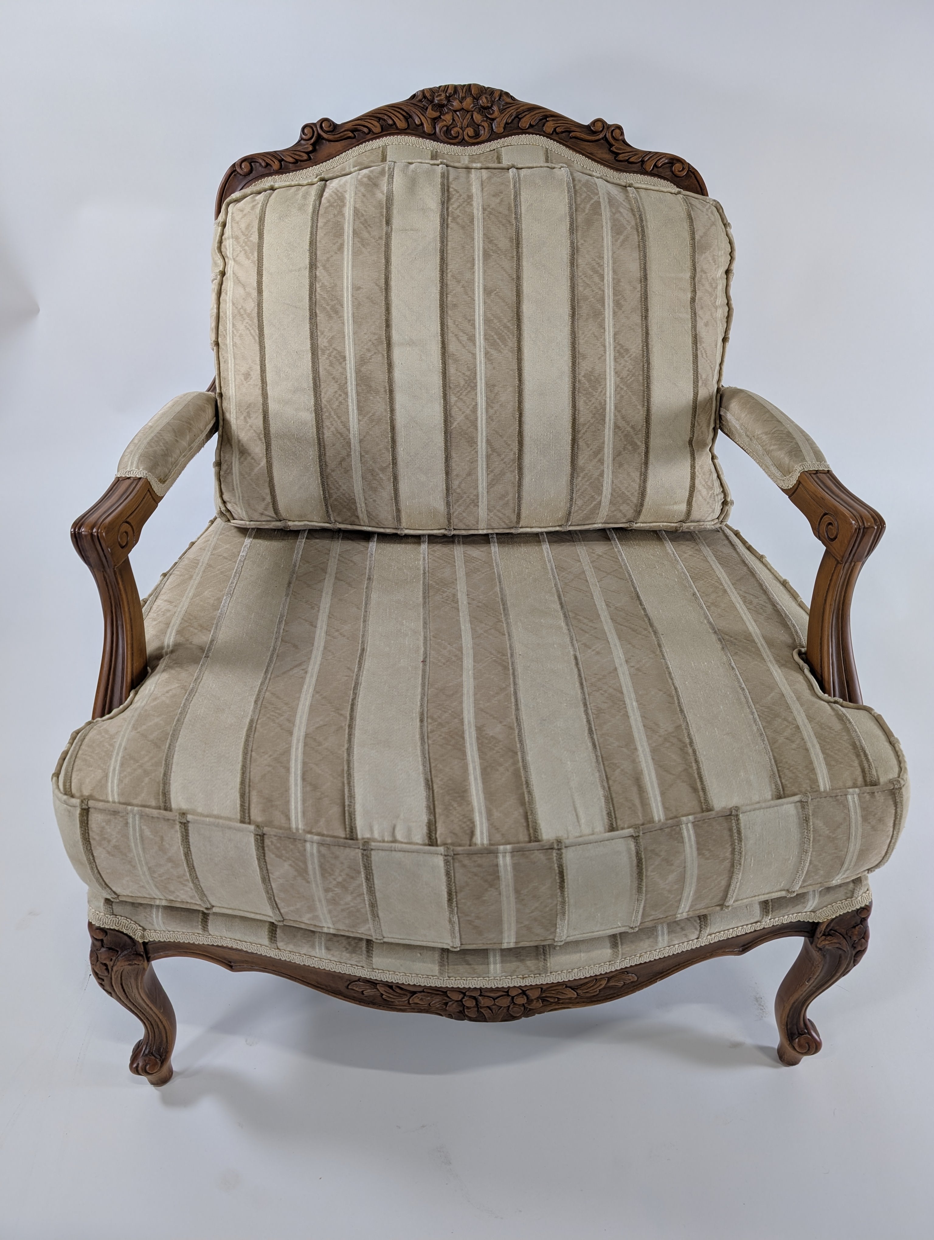 Ornate Carved Wood Armchair with Striped Upholstery