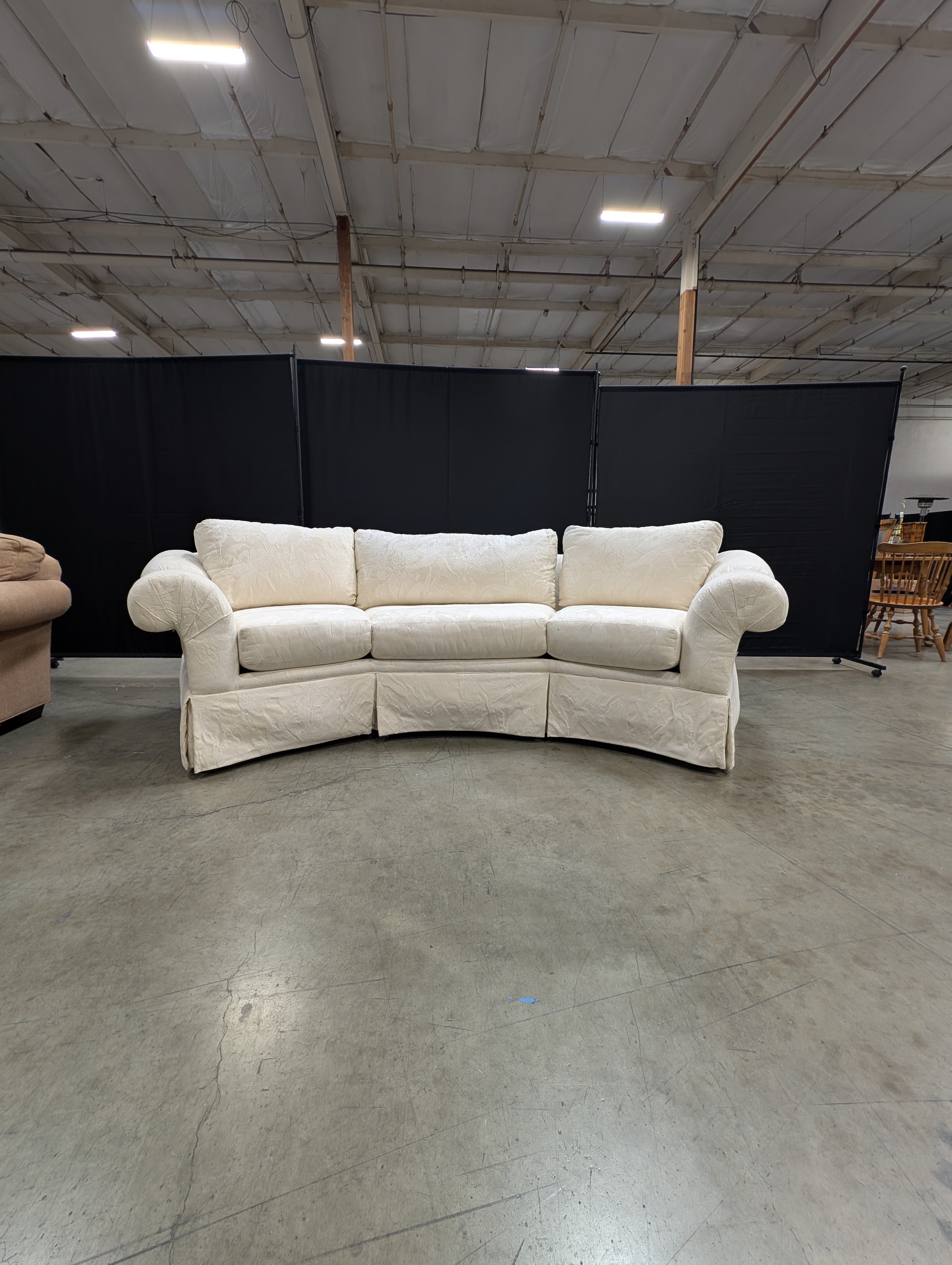 Has a stain Curved Cream Fabric Sectional Sofa with Rolled Arms