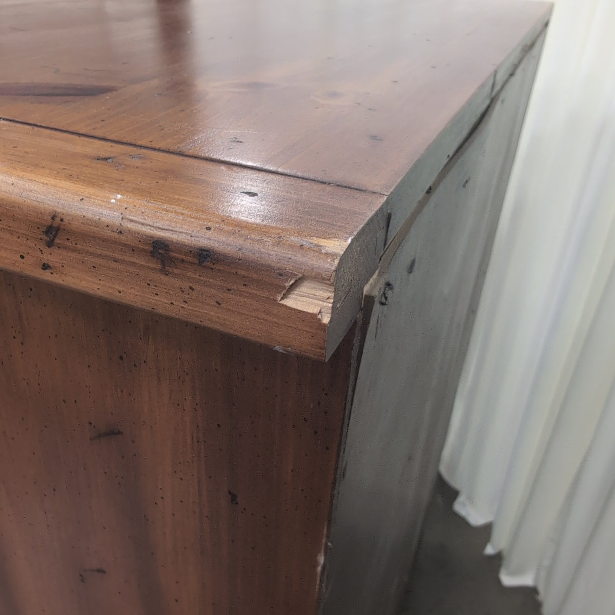 Honey-Toned Wood Four-Drawer Dresser with Decorative Molding