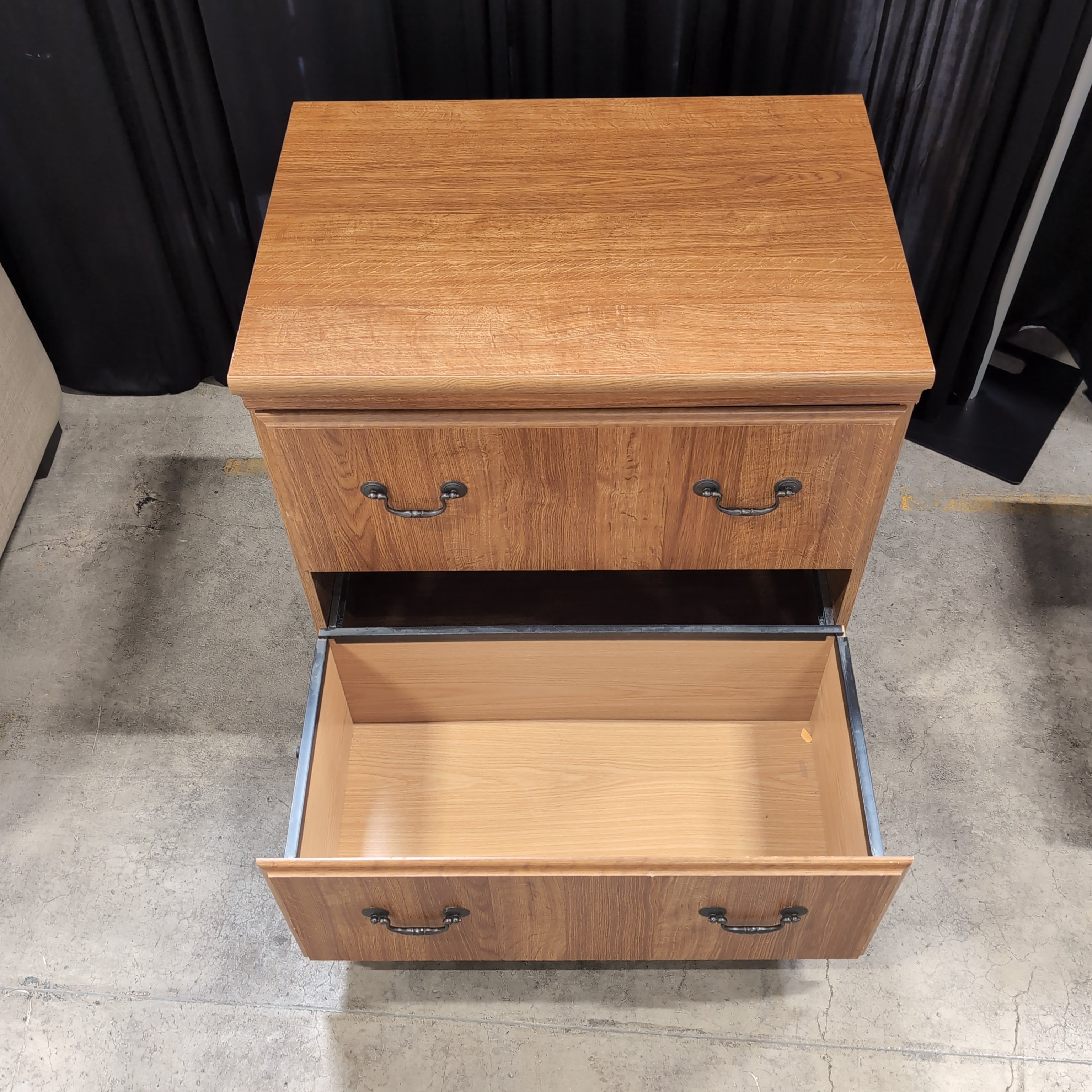 Brown Wood Three-Drawer Dresser with Dark Metal Pulls