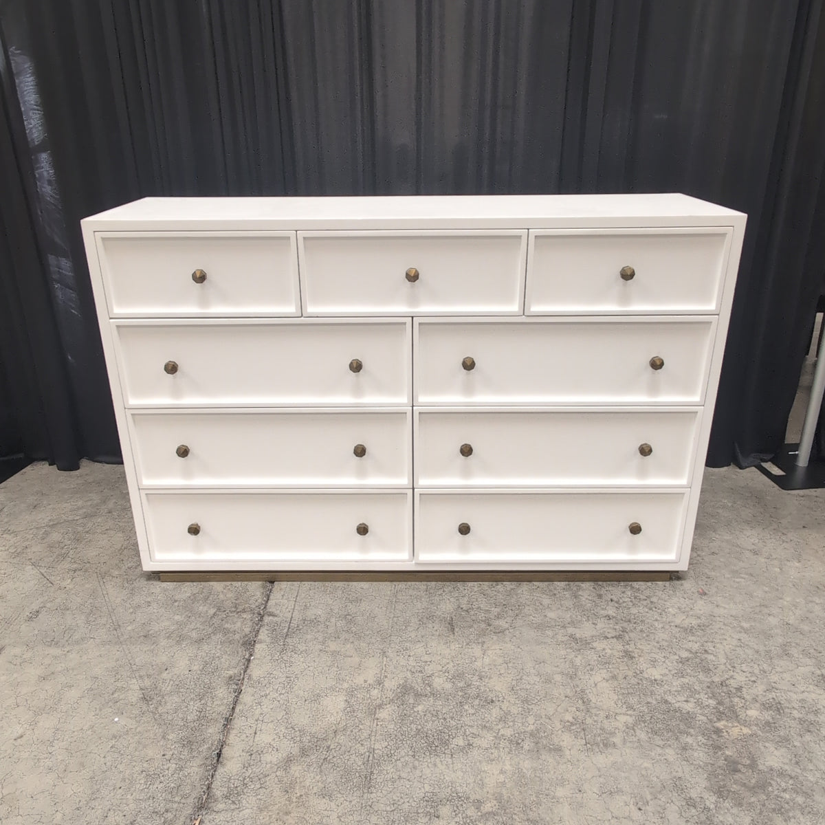 Clean-Lined White Nine-Drawer Dresser with Brass Knobs