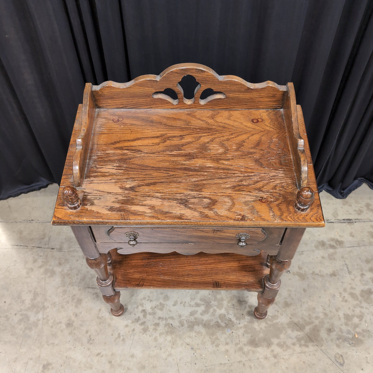 Dark Stained Wood Nightstand with Ornate Hardware