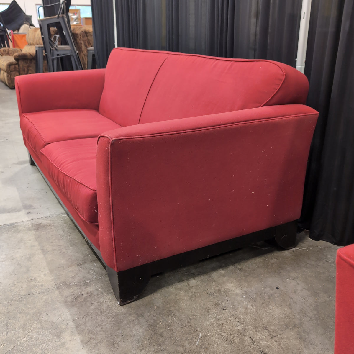 Red Fabric Upholstered Two-Cushion Couch