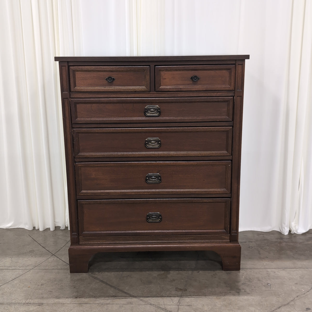 Brown Wood Six-Drawer Dresser with Ornate Hardware