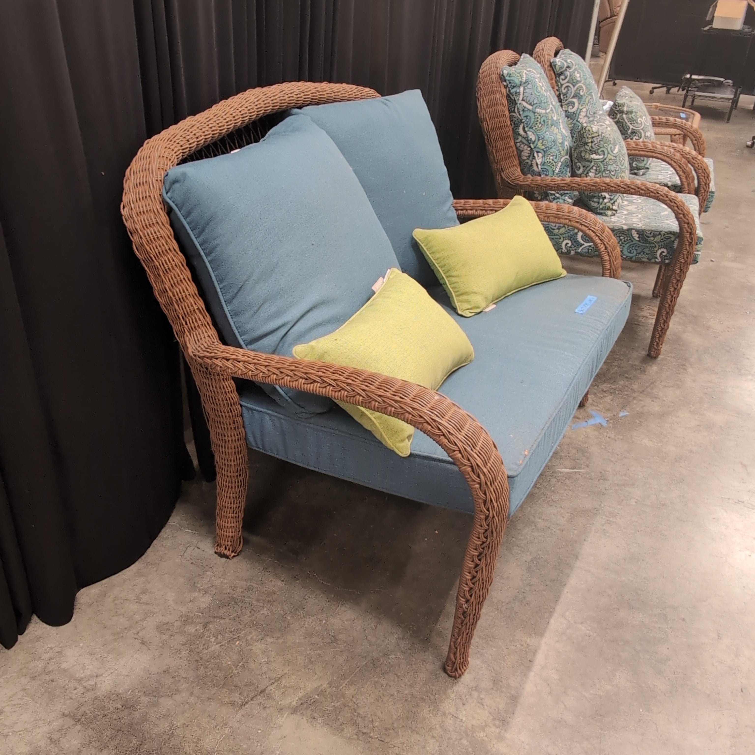 Brown Wicker Outdoor Loveseat with Blue Cushions