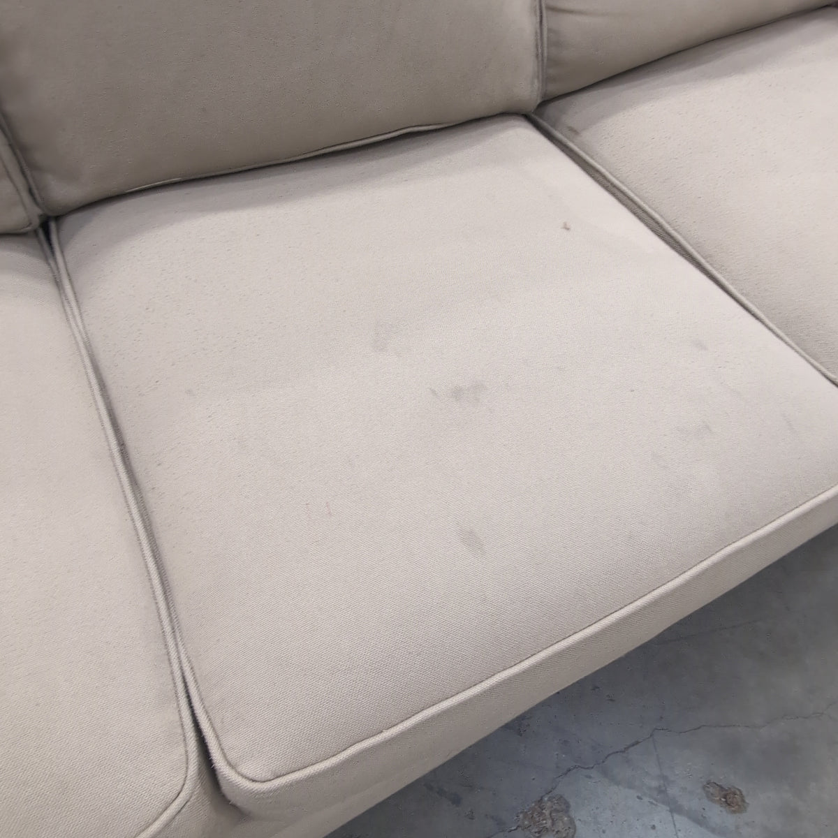 Tan Fabric Three-Cushion Couch with Rolled Arms