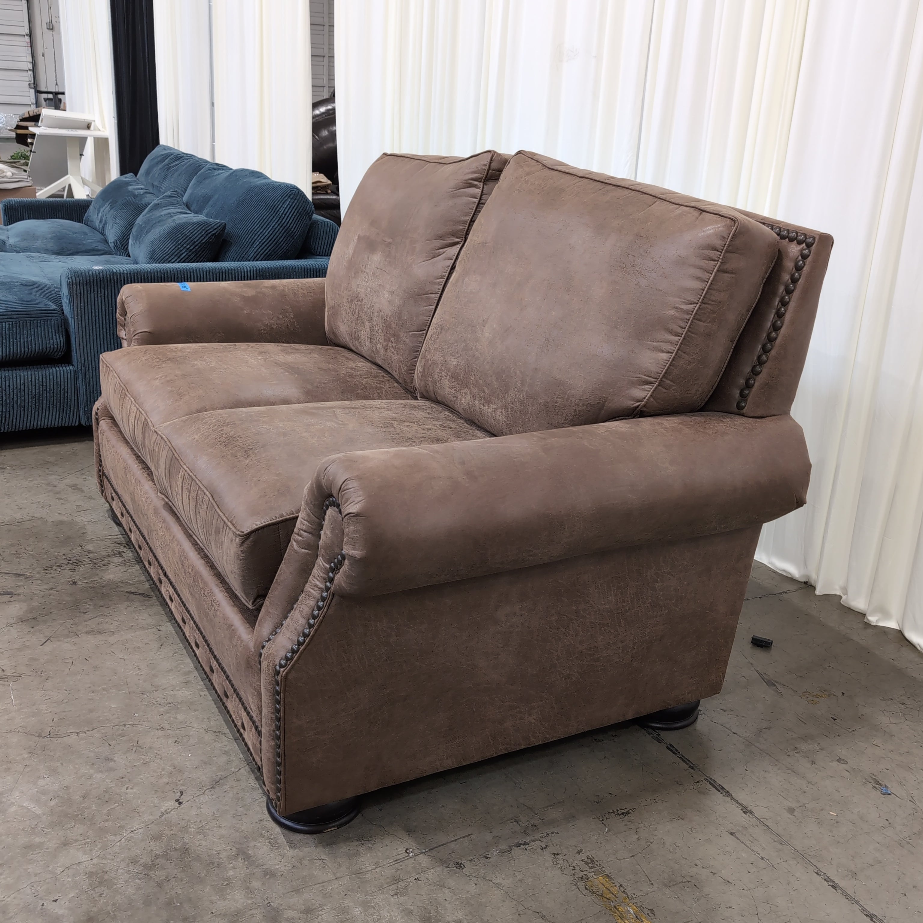 Tan Faux Leather Rolled Arm Loveseat with Nailhead Trim