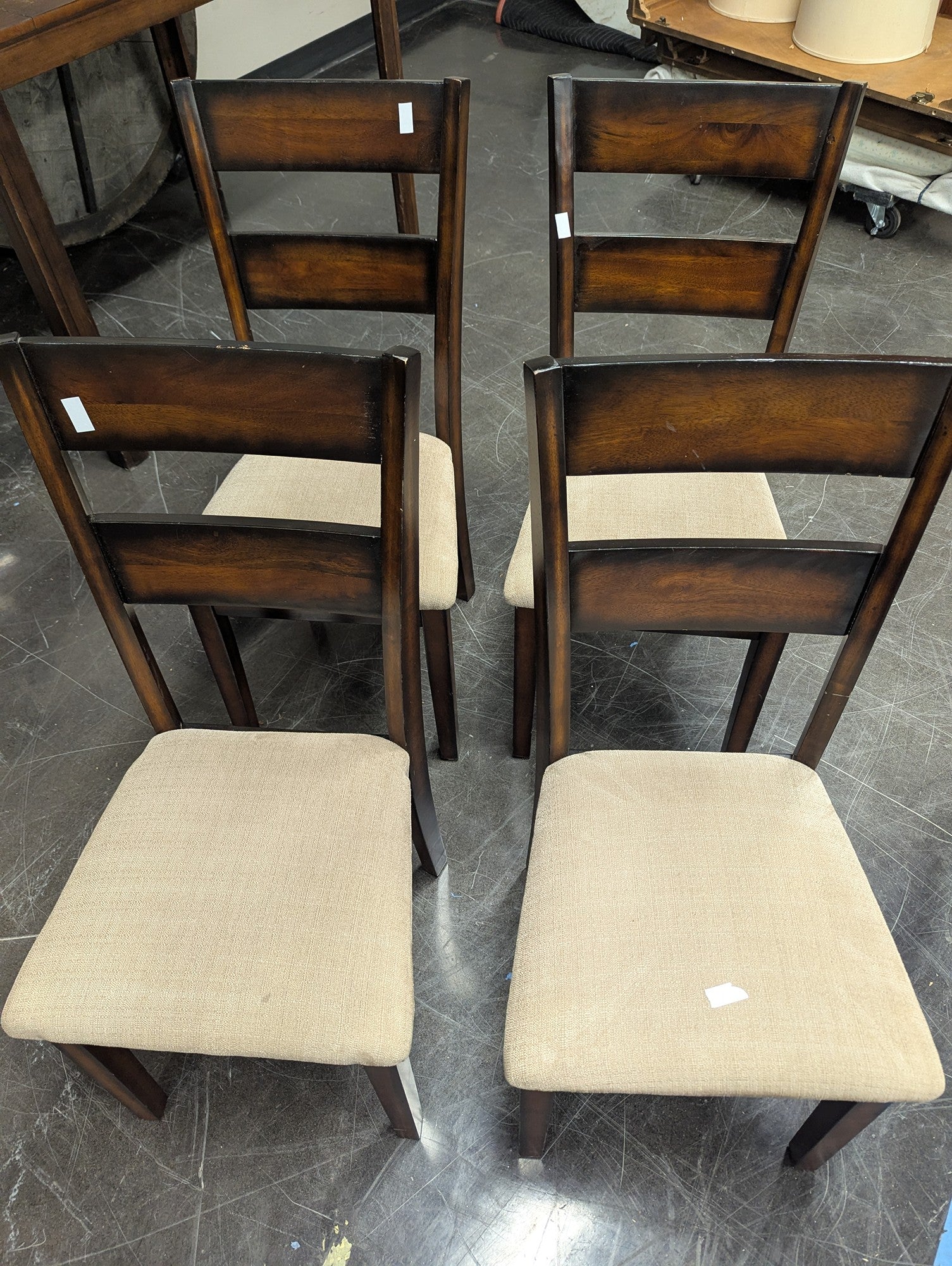 Set of Four Brown Wood Dining Chairs with Beige Cushions