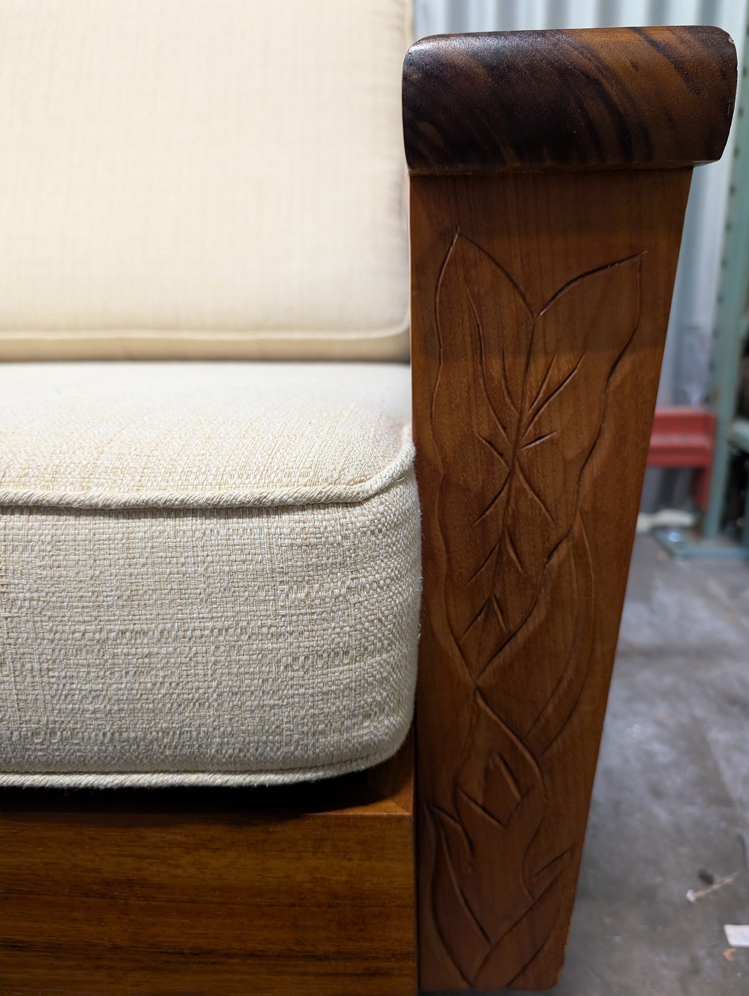 Mid-Century Style Wooden Sofa with Carved Leaf Arms and Cream Cushions
