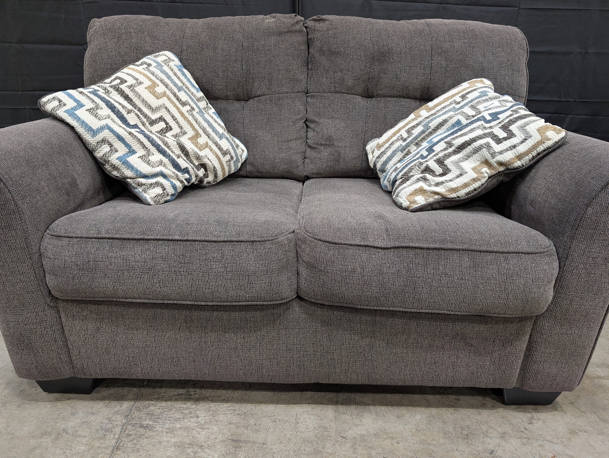 Compact Grey Textured Fabric Loveseat with Accent Pillows