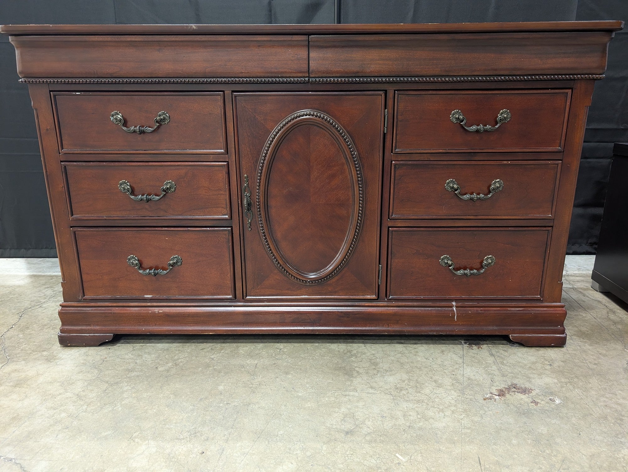 Traditional Dark Wood Dresser with Ornate Hardware
