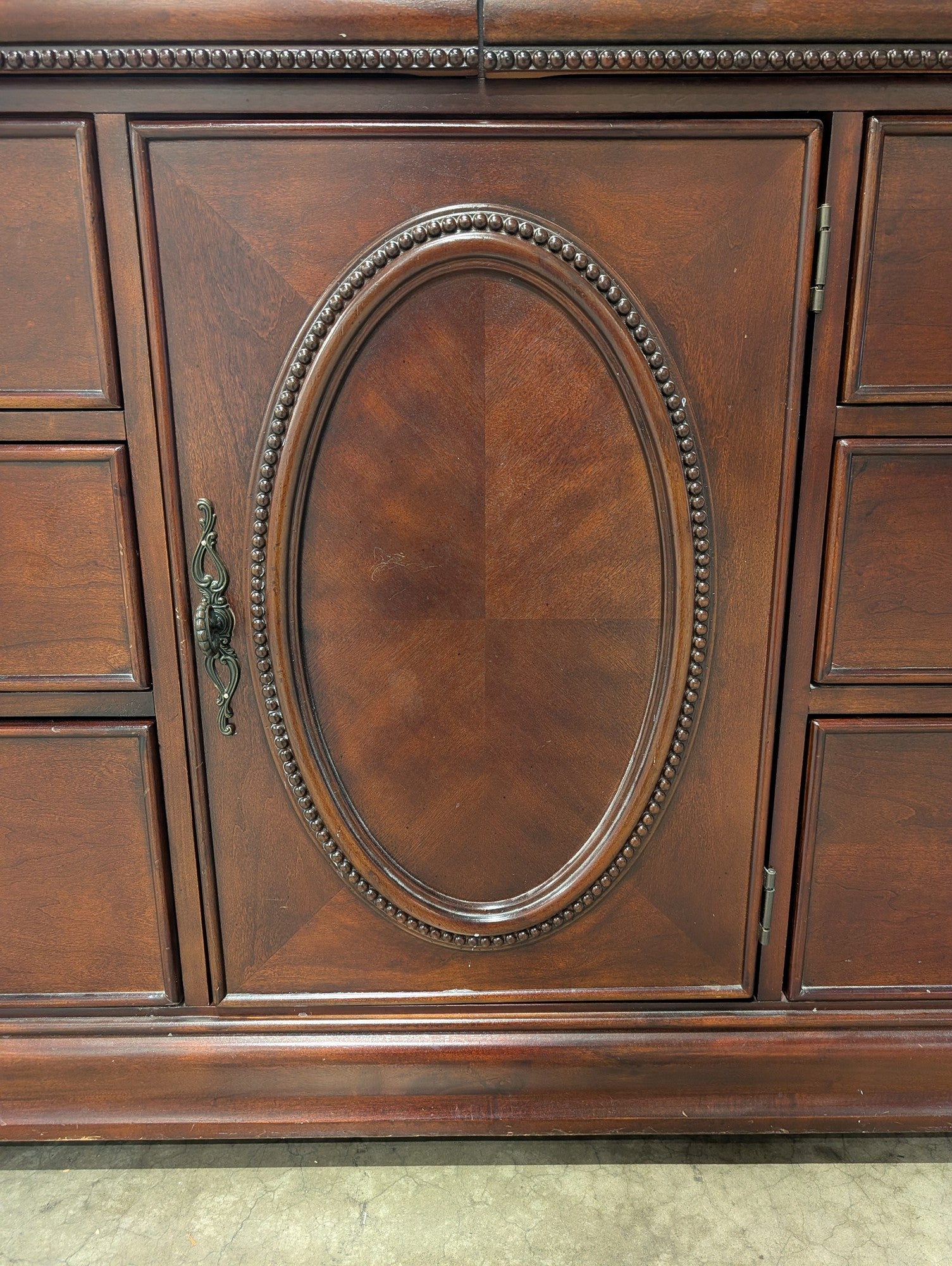 Traditional Dark Wood Dresser with Ornate Hardware