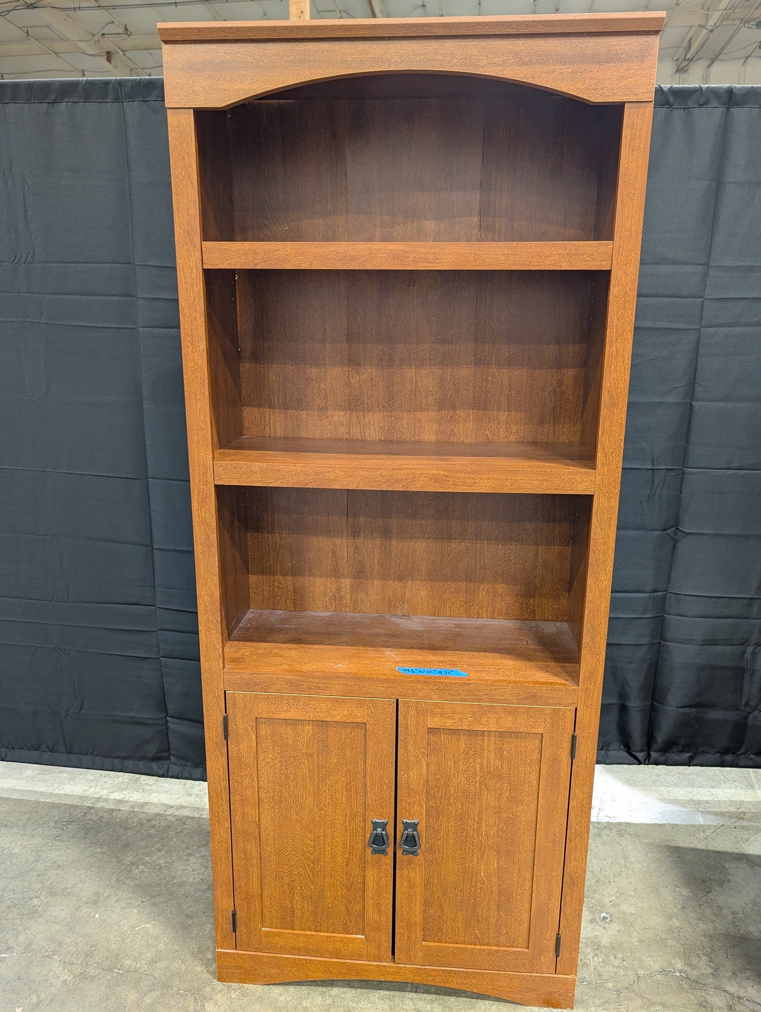 Sturdy Reddish-Brown Wood Bookcase with Arched Top and Cabinet