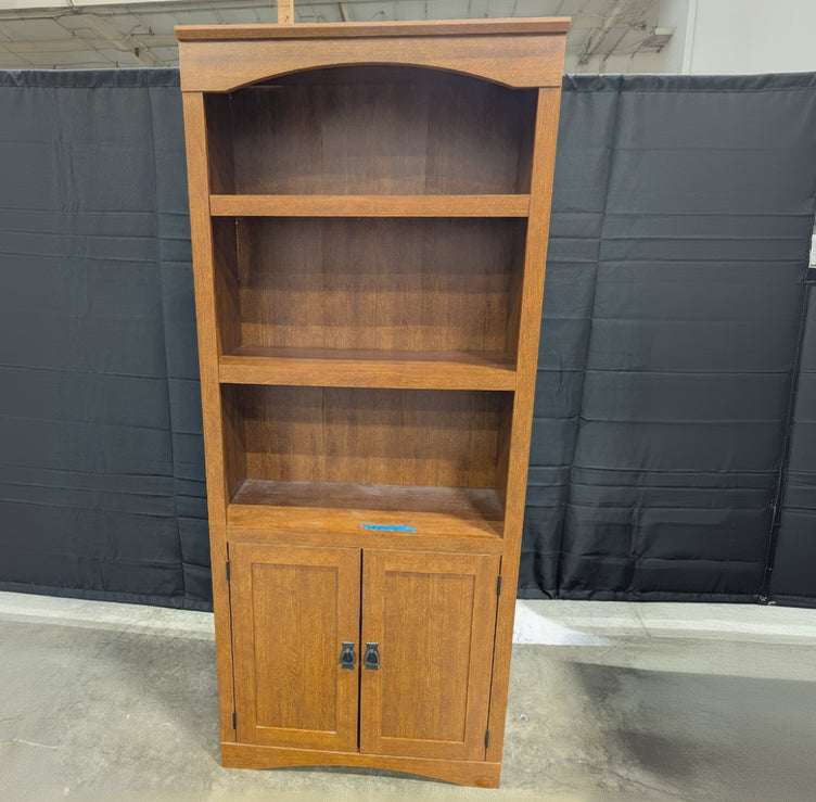 Sturdy Reddish-Brown Wood Bookcase with Arched Top and Cabinet