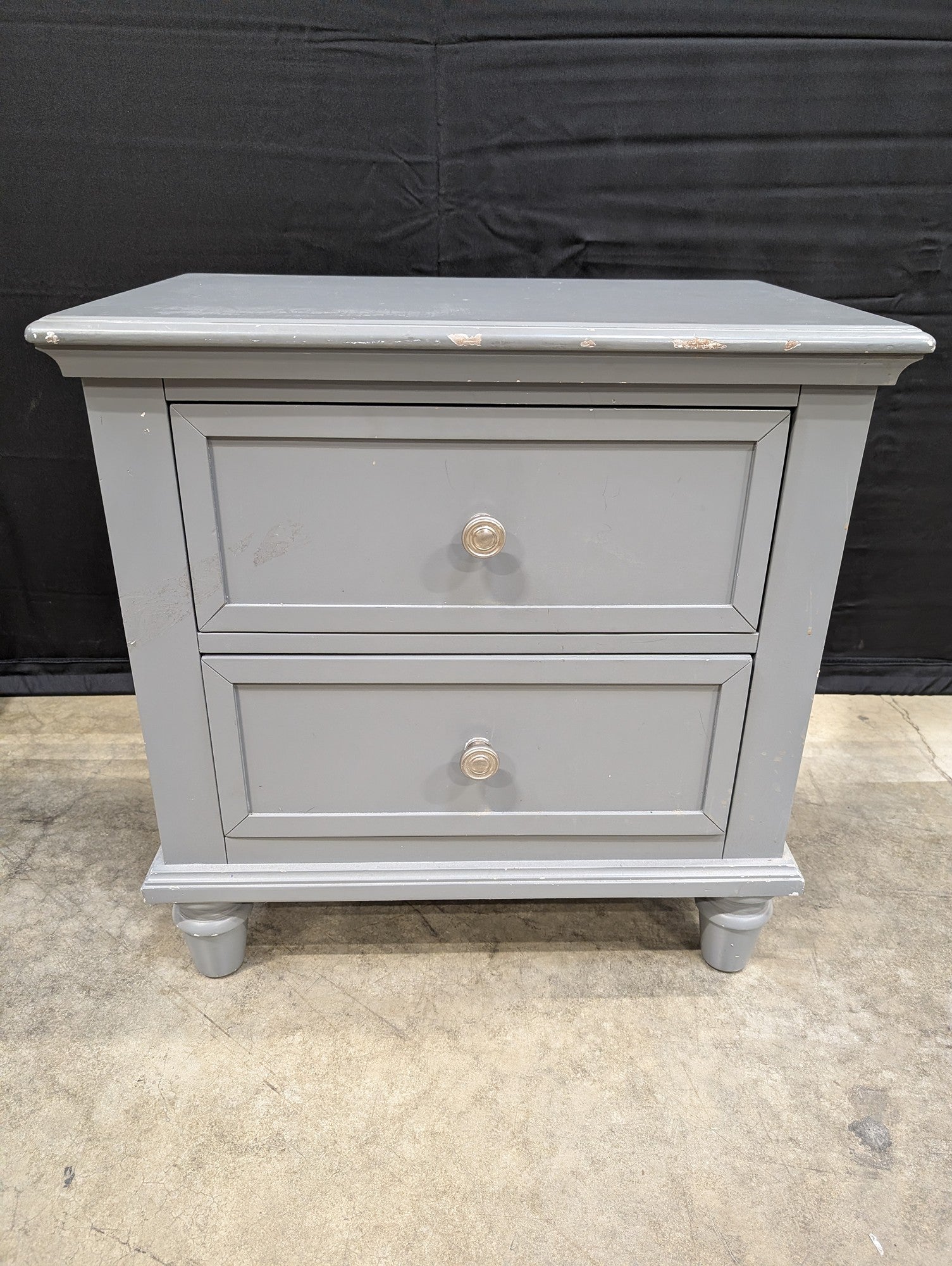 Charming Grey Two-Drawer Nightstand with Turned Feet