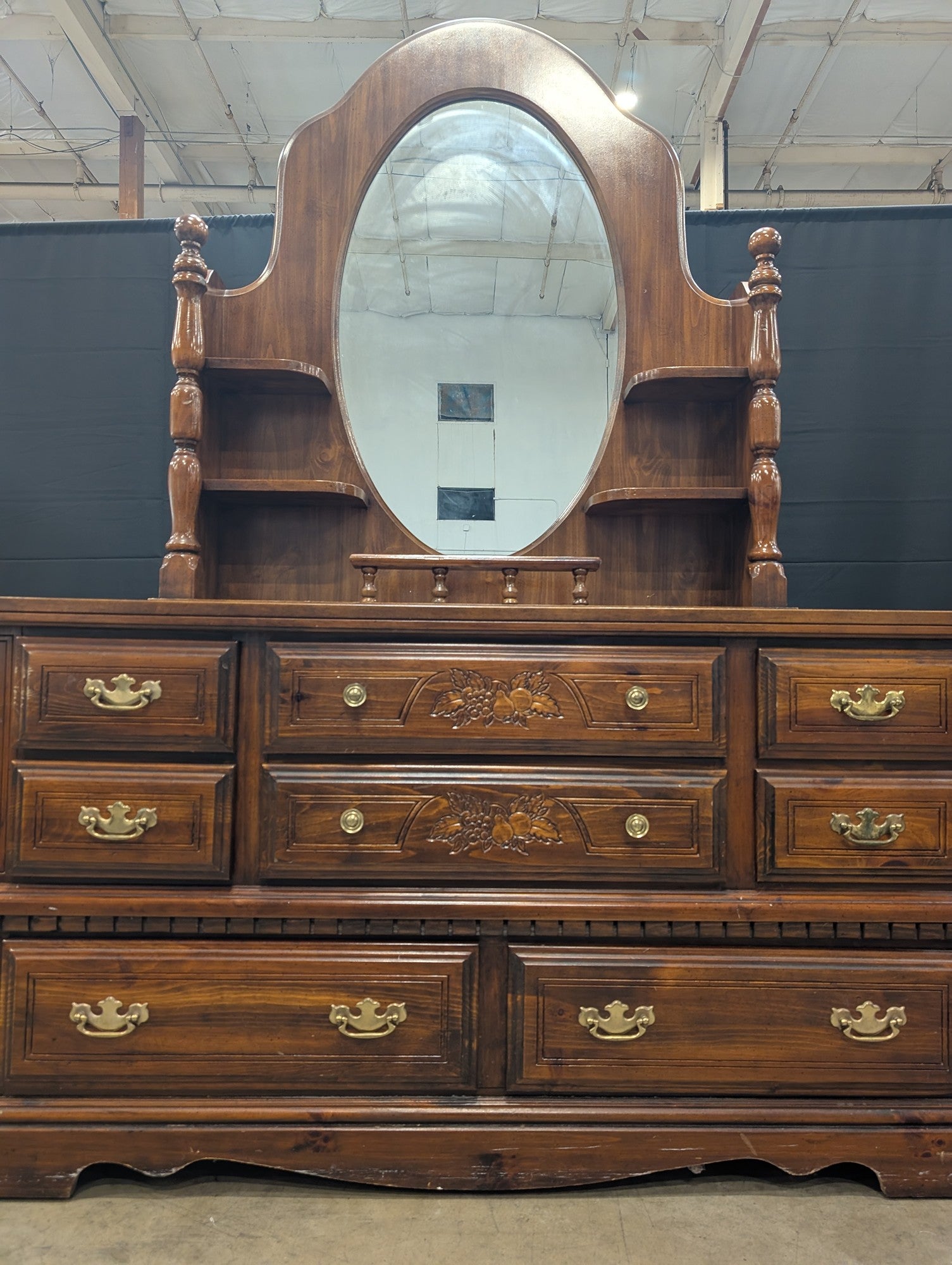 Traditional Dark Wood Dresser with Oval Mirror and Carved Accents