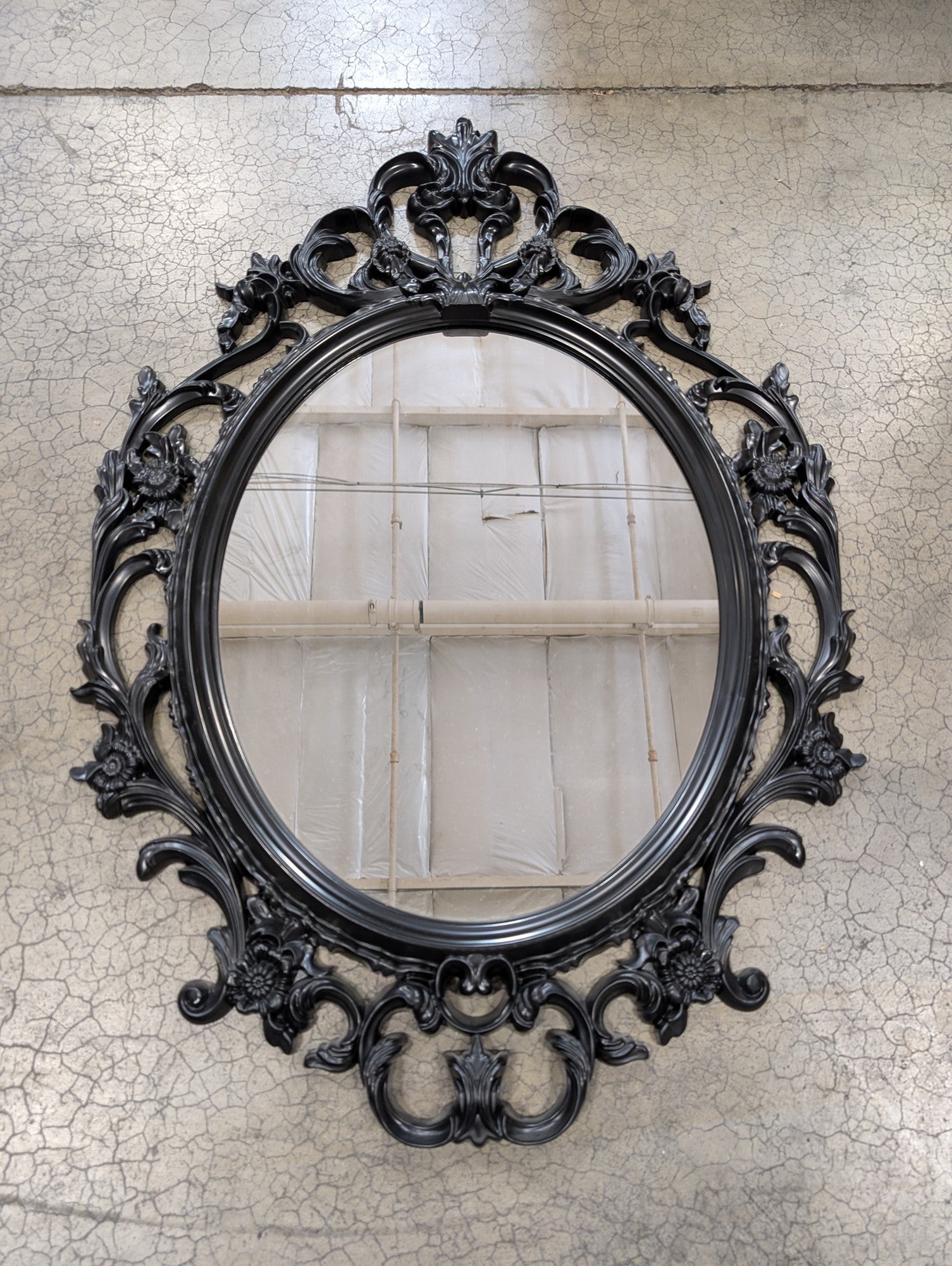 Ornate Black Oval Wall Mirror with Rococo-Inspired Plastic Frame