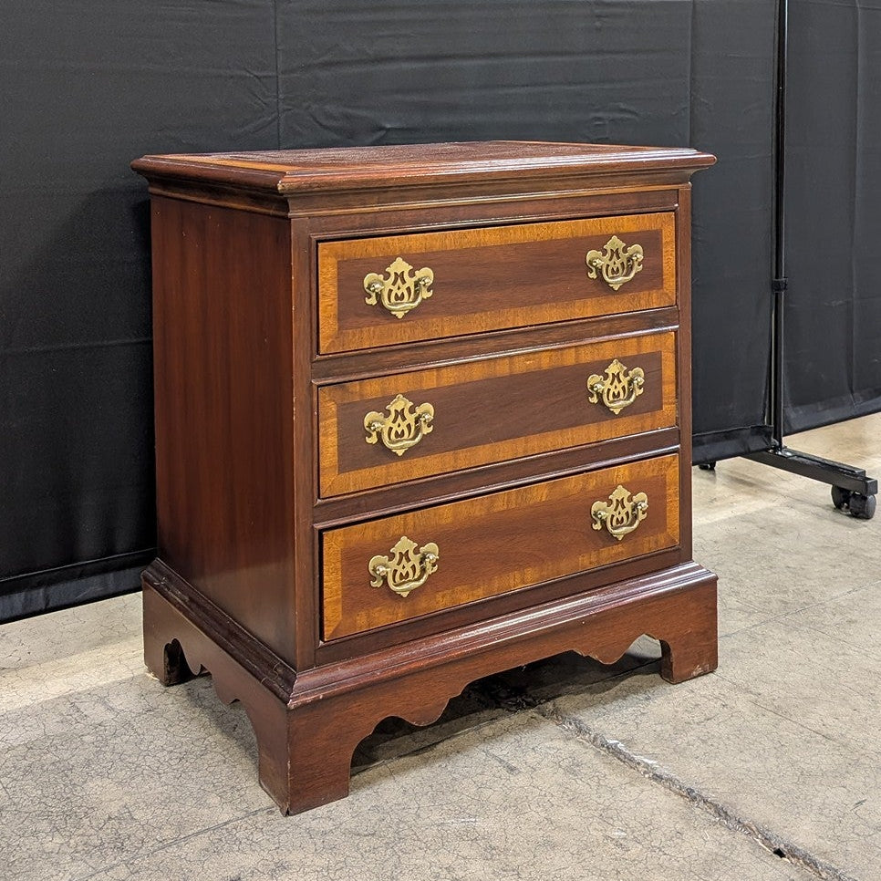 Traditional Dark Wood Three-Drawer Chest with Ornate Brass Pulls