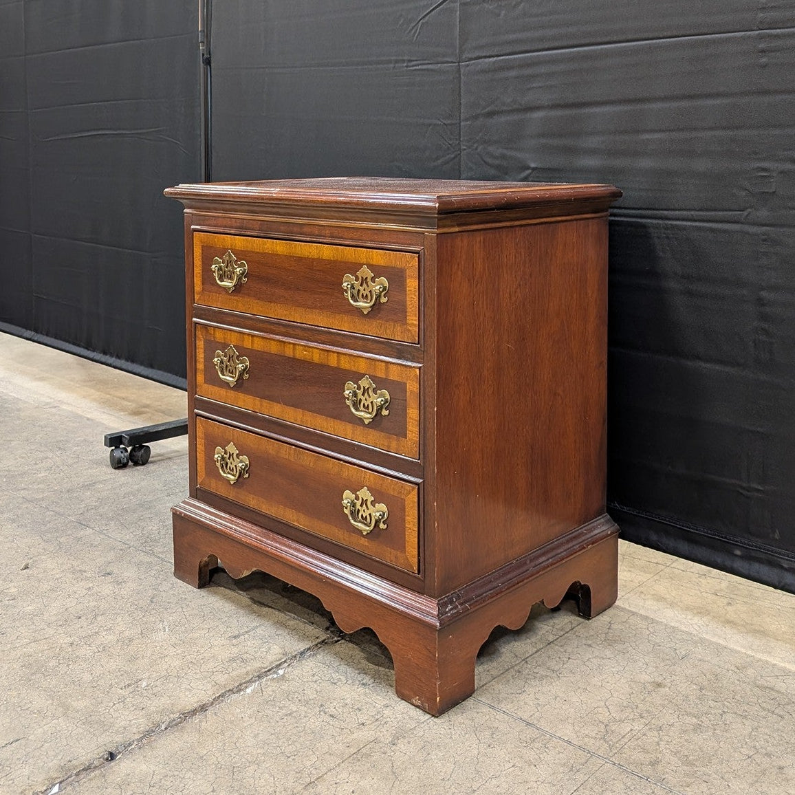 Traditional Dark Wood Three-Drawer Chest with Ornate Brass Pulls