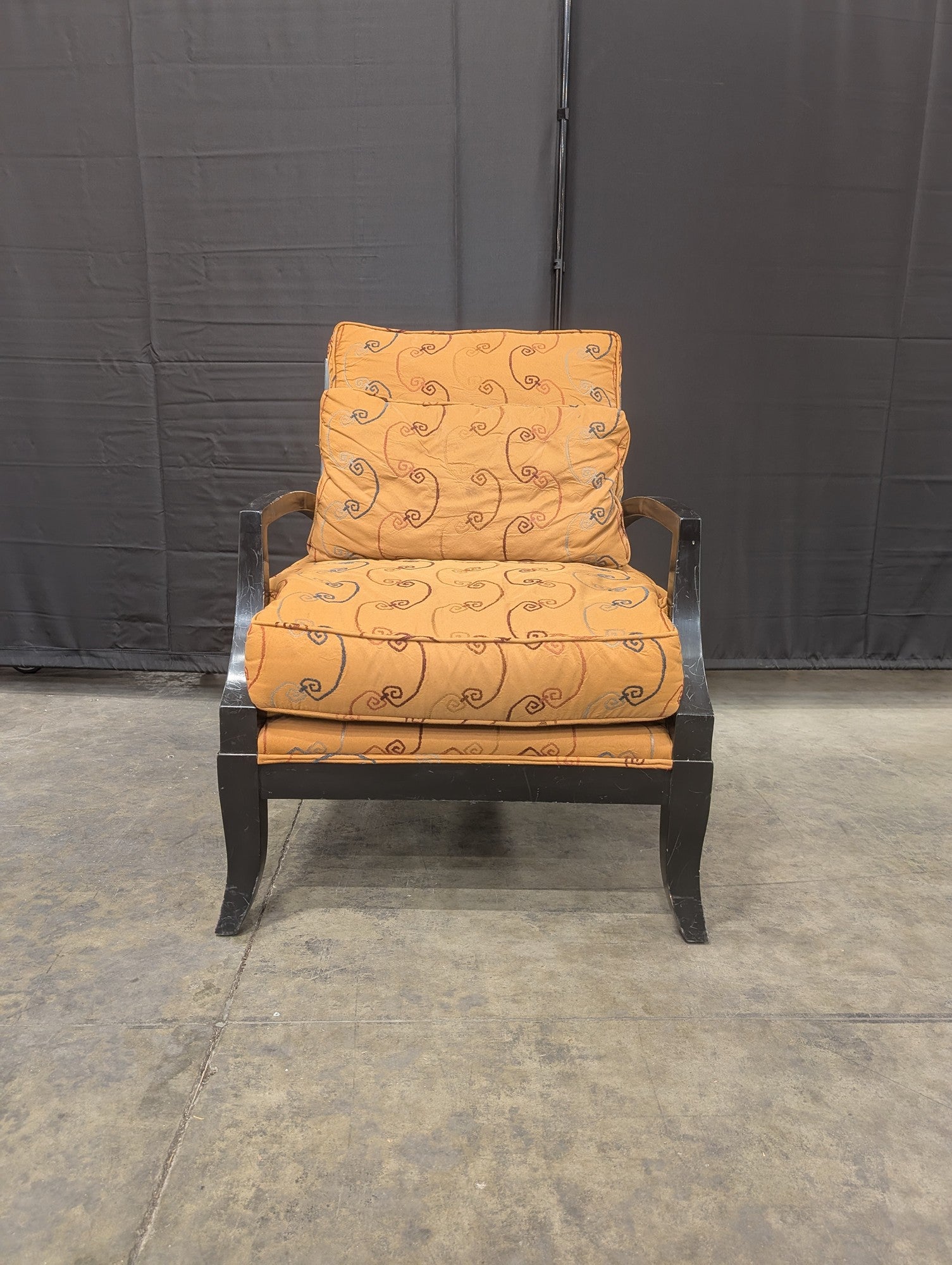 Orange Patterned Upholstered Armchair with Dark Wood Frame