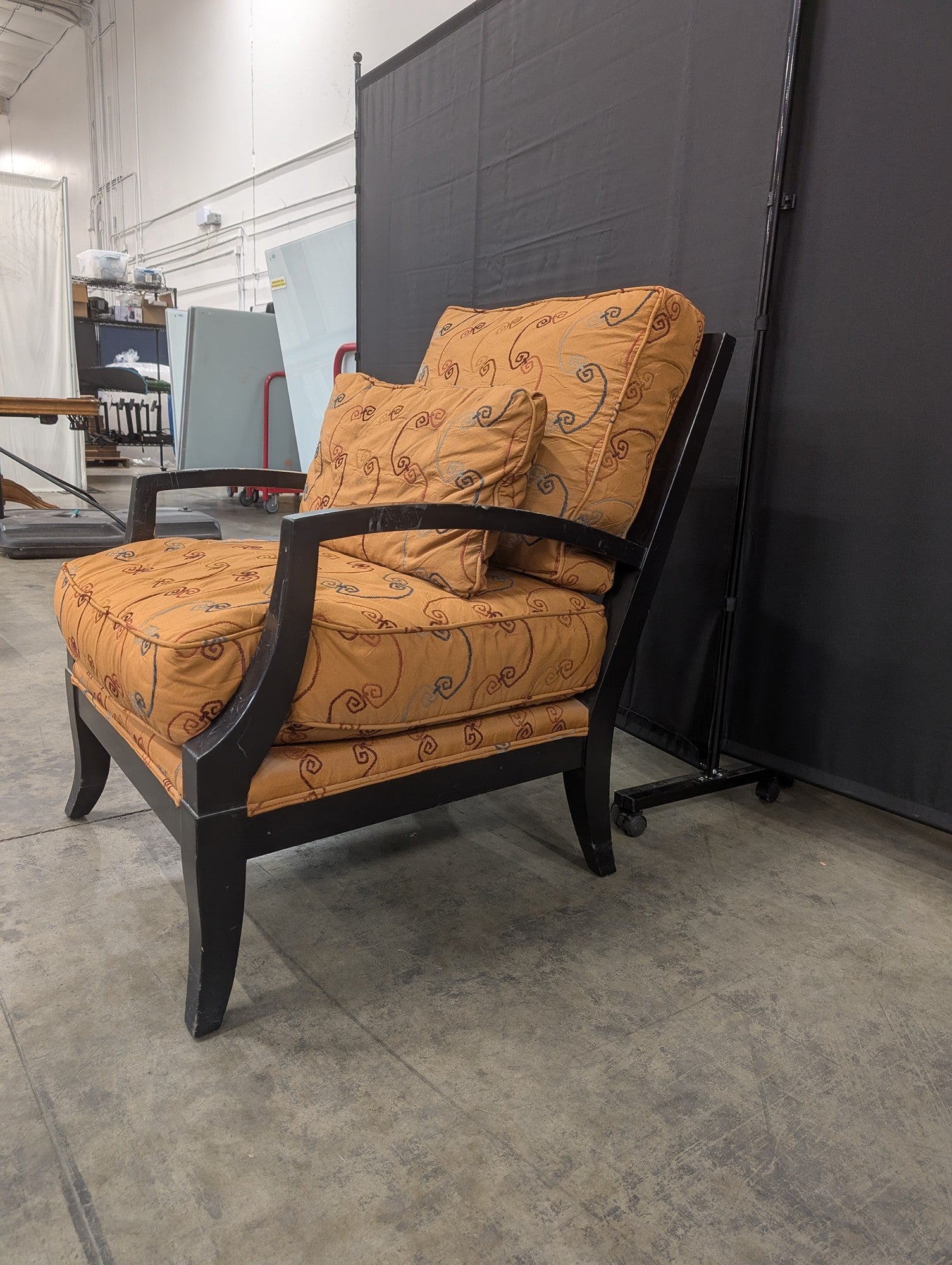 Orange Patterned Upholstered Armchair with Dark Wood Frame